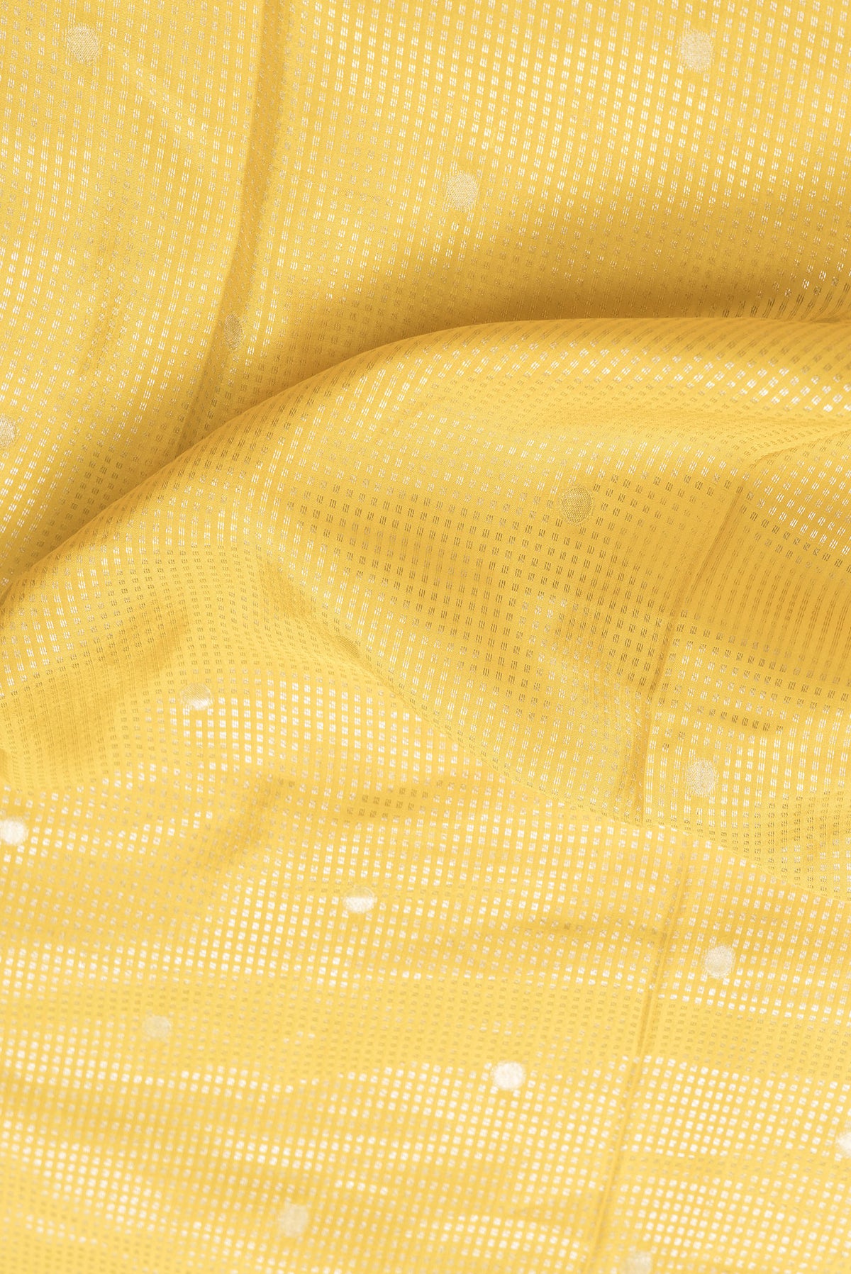 Close up of Yellow Dual Tone Mysore Silk Saree with Zari Brocade on the body and Fancy Border.  displaying folds
