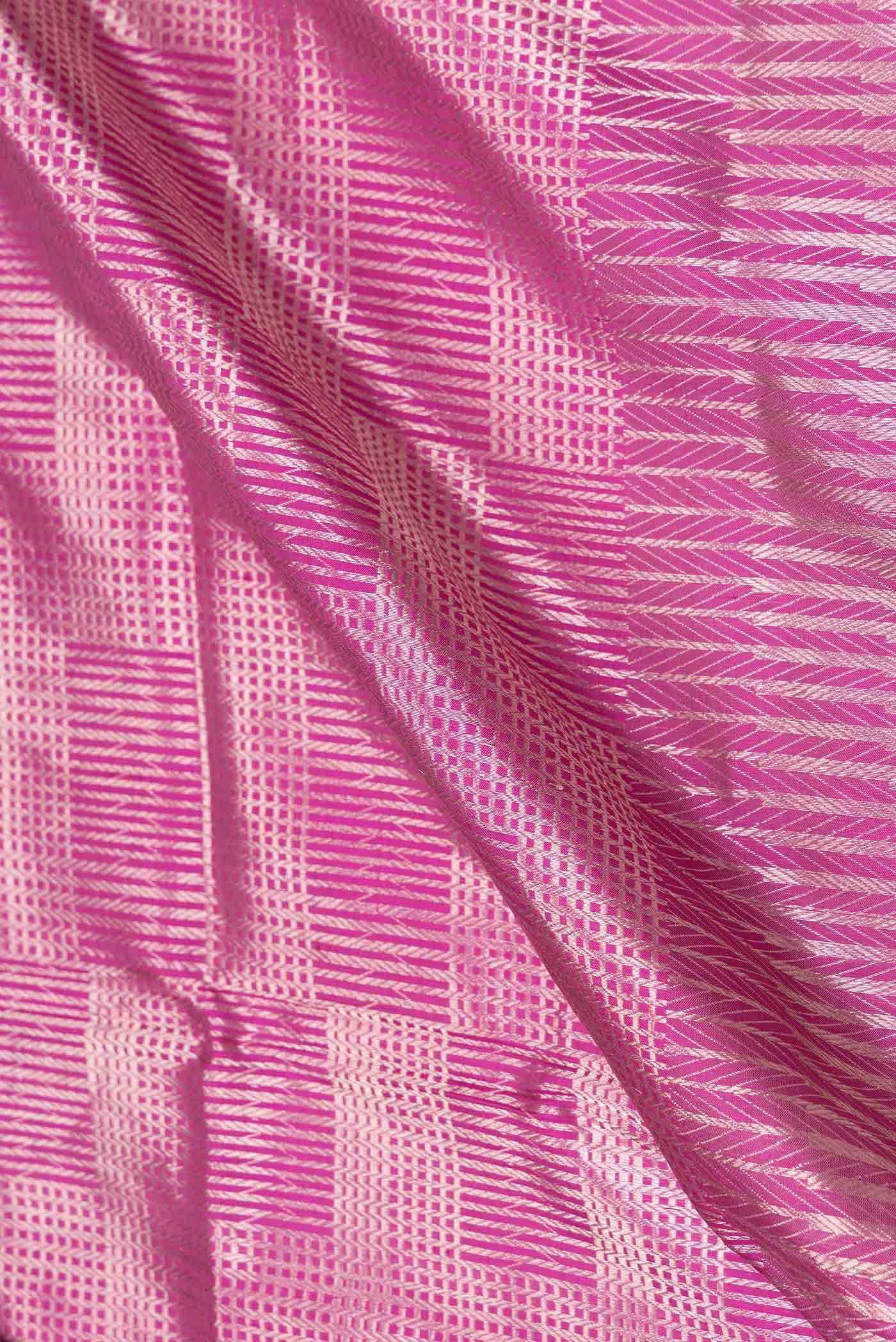Close up of Magenta Banarasi Silk Saree with Zari Brocade on the body and Zari Border displaying folds