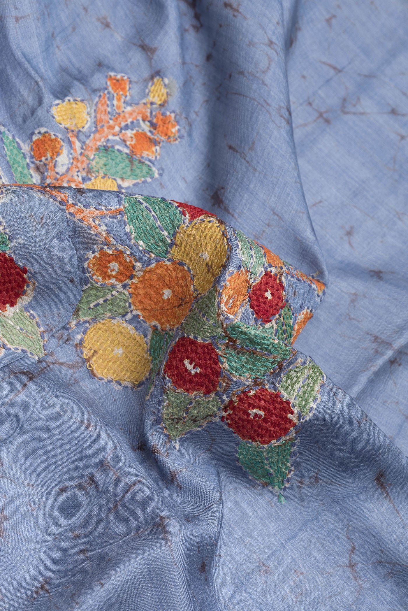 Close up of Blue Tussar Silk Saree with Kantha Work on the body and Embroidery Border.  displaying folds