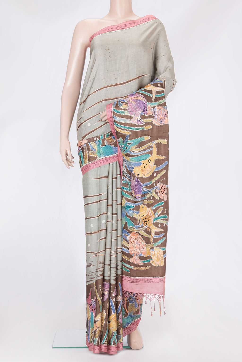 Grey Tussar Silk Saree with Embroidery on the body and Embroidery Border.  displayed on a mannequin