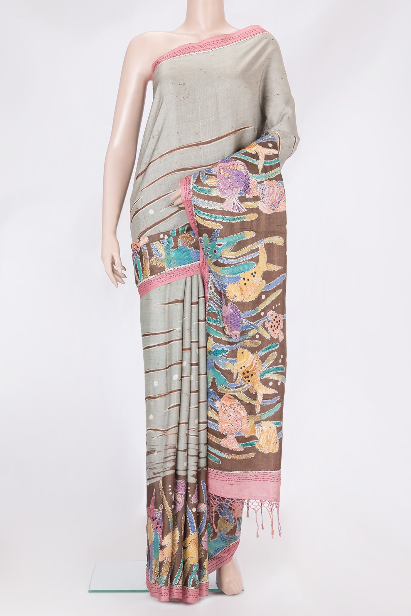 Grey Tussar Silk Saree with Embroidery on the body and Embroidery Border.  displayed on a mannequin
