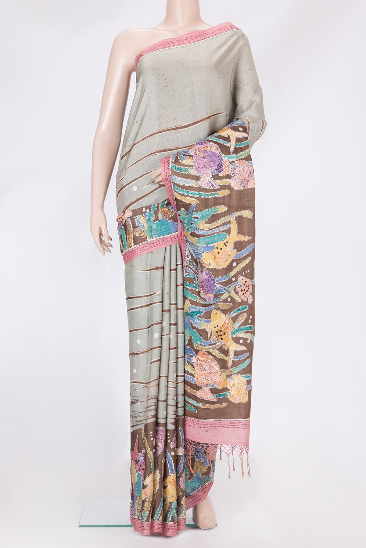Grey Tussar Silk Saree with Embroidery on the body and Embroidery Border.  displayed on a mannequin