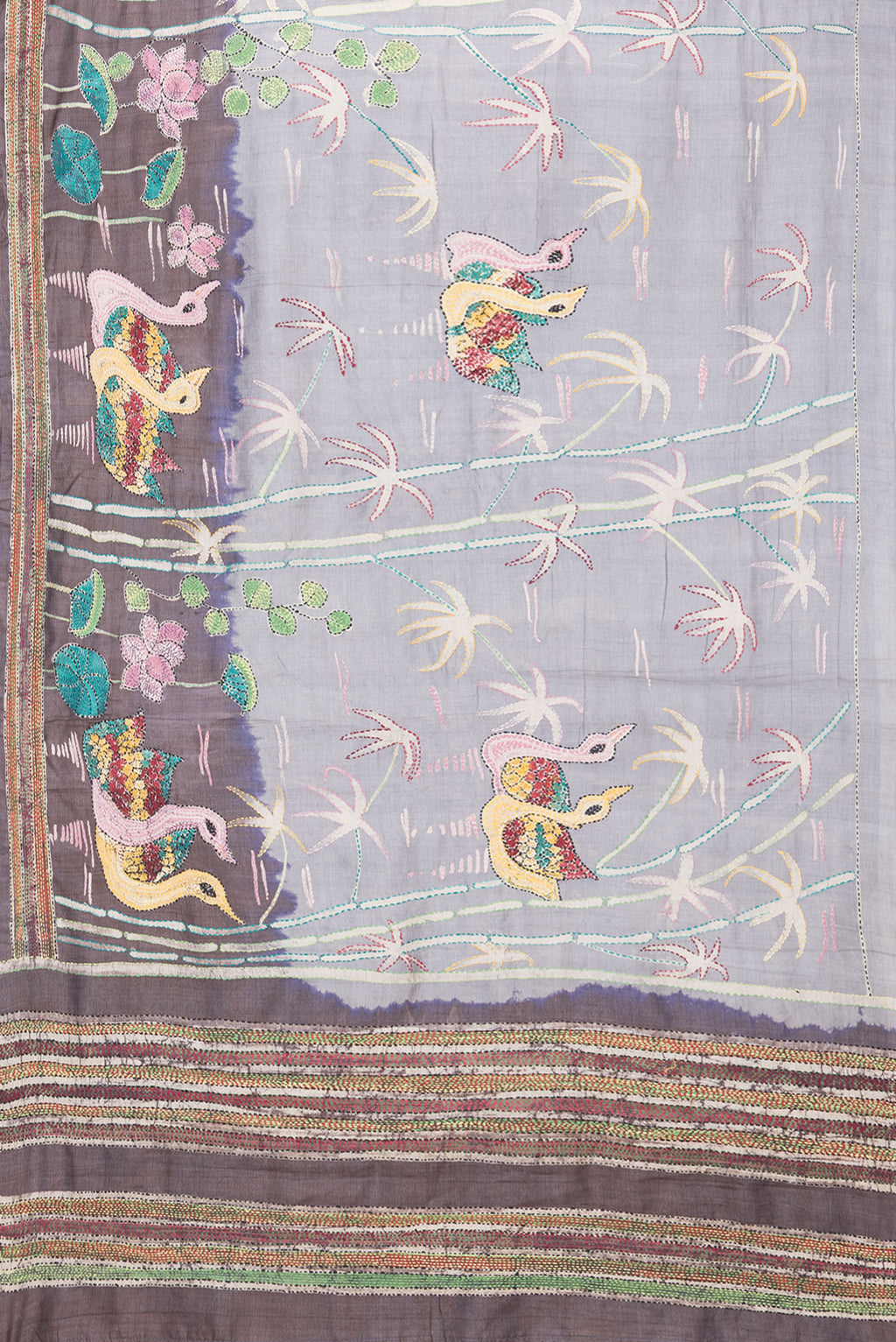 Flat view of Grey Tussar Silk Saree with Embroidery on the body and Embroidery Border. 