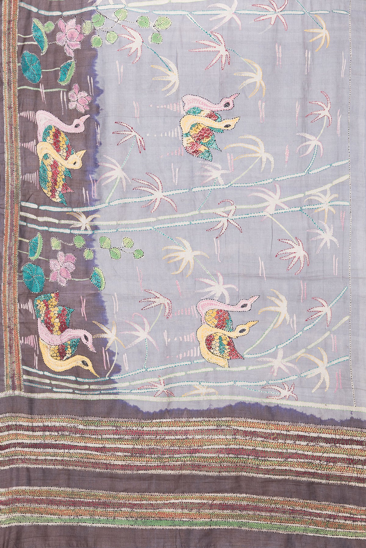 Flat view of Grey Tussar Silk Saree with Embroidery on the body and Embroidery Border. 