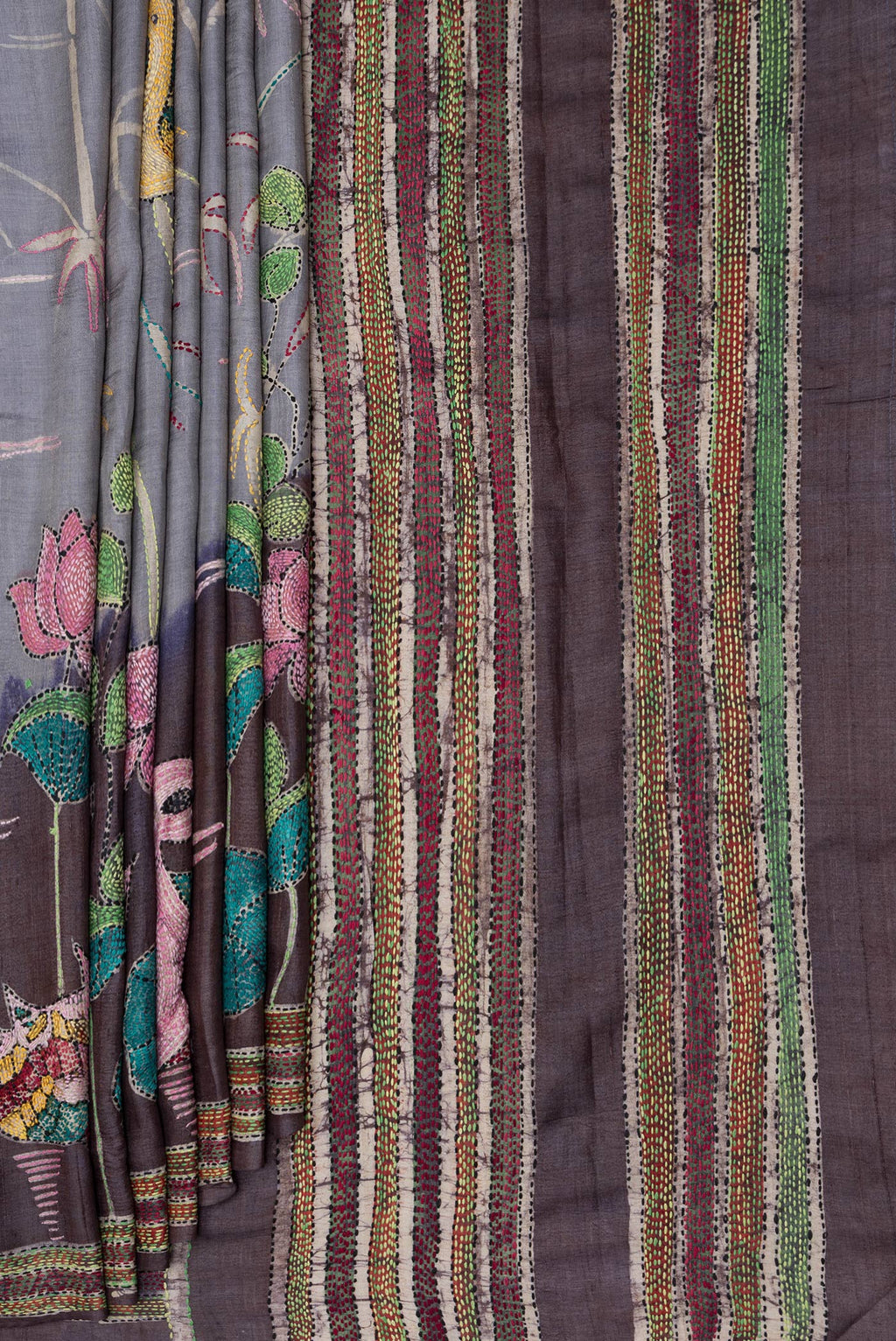 Pleats and pallu of Grey Tussar Silk Saree with Embroidery on the body and Embroidery Border. 
