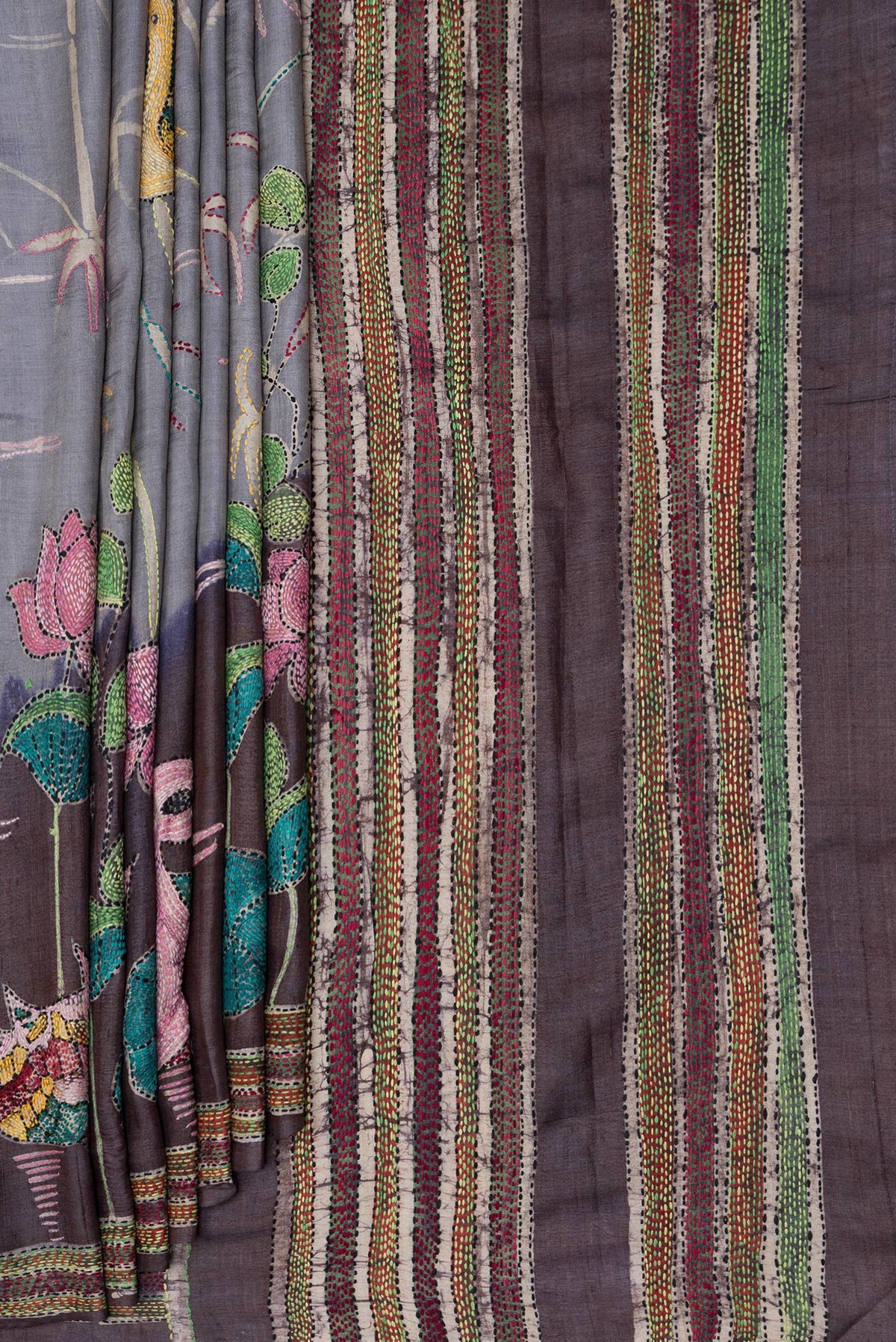 Pleats and pallu of Grey Tussar Silk Saree with Embroidery on the body and Embroidery Border. 