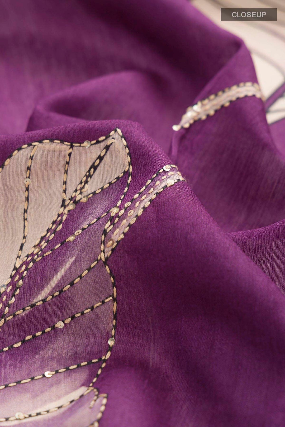 Close up of Magenta Bhagalpuri Tussar Silk Saree with Embroidery on the body and Plain Border displaying folds