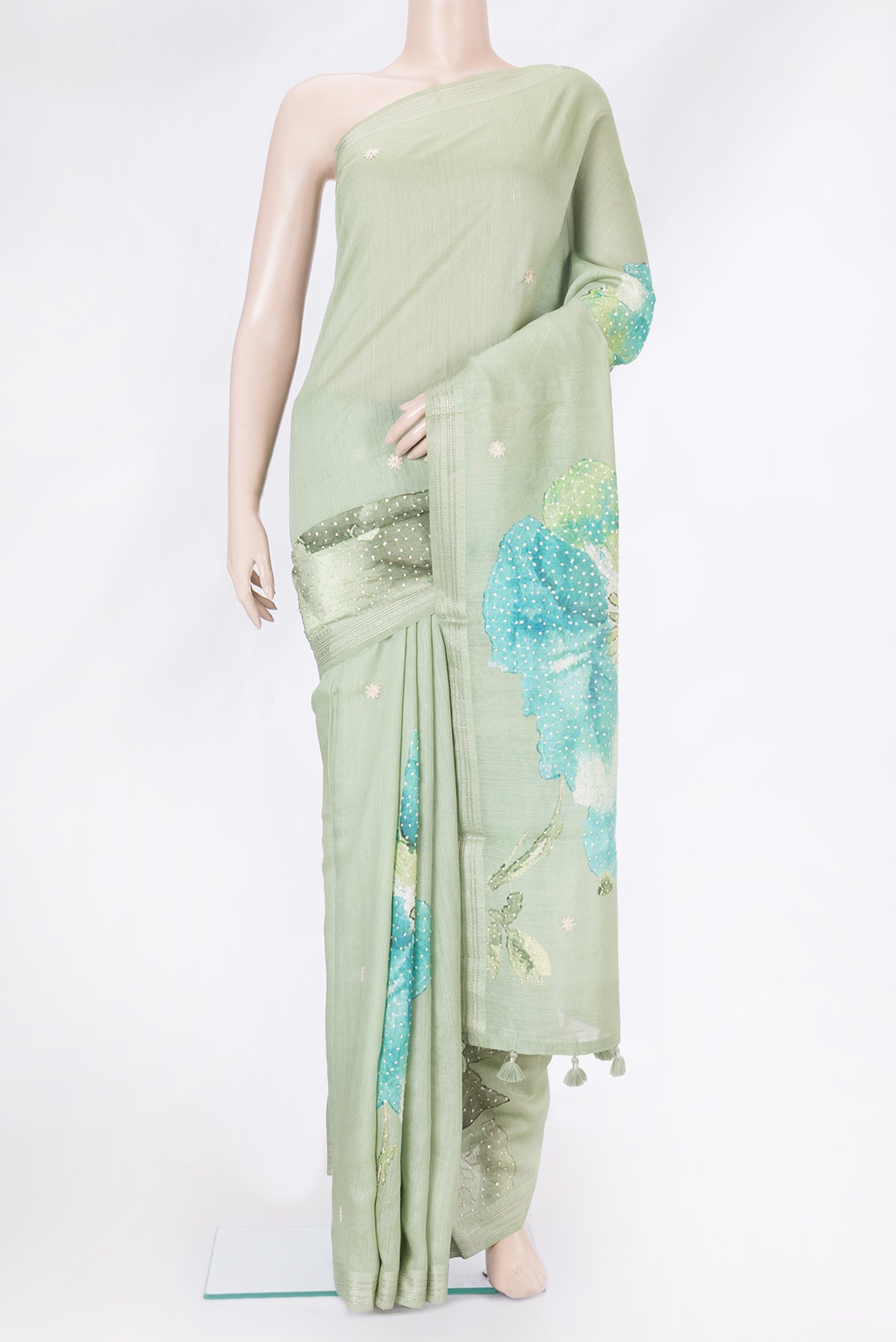 Pista Green Tussar Silk Saree with Embroidery on the body and Zari Border.  displayed on a mannequin