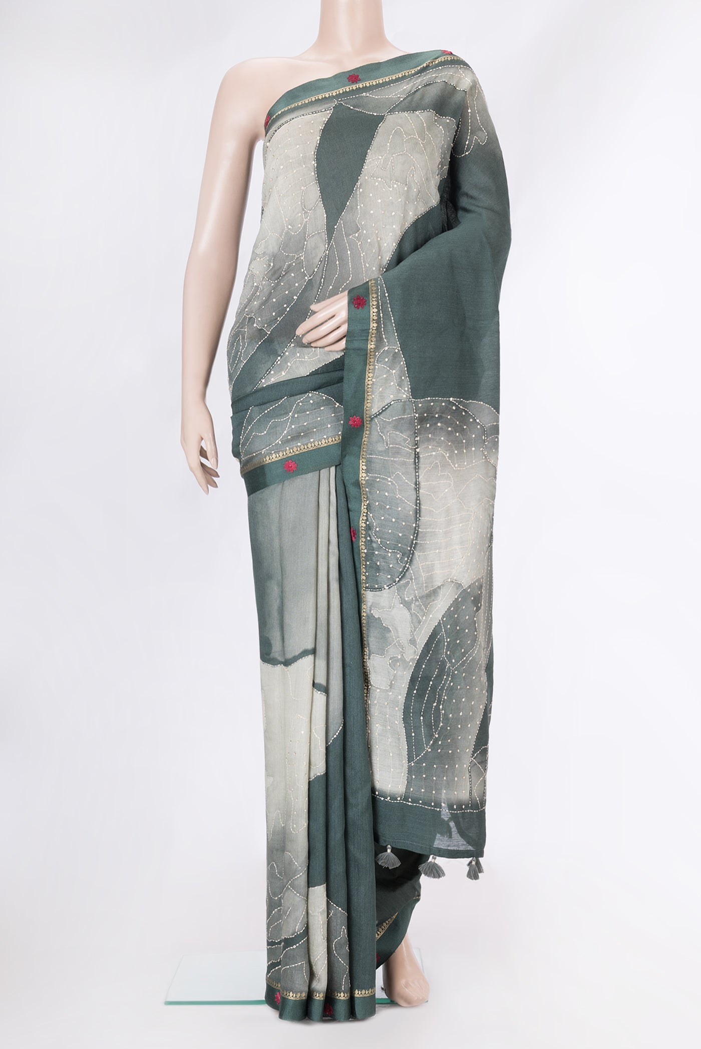 Grey Tussar Silk Saree with Embroidery on the body and Embroidery Border.  displayed on a mannequin