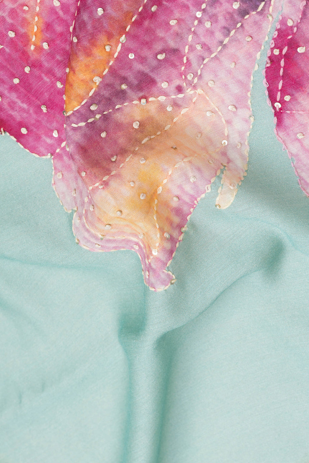 Close up of Sea Green Dual Tone Tussar Silk Saree with Embroidery on the body and Zari Border.  displaying folds