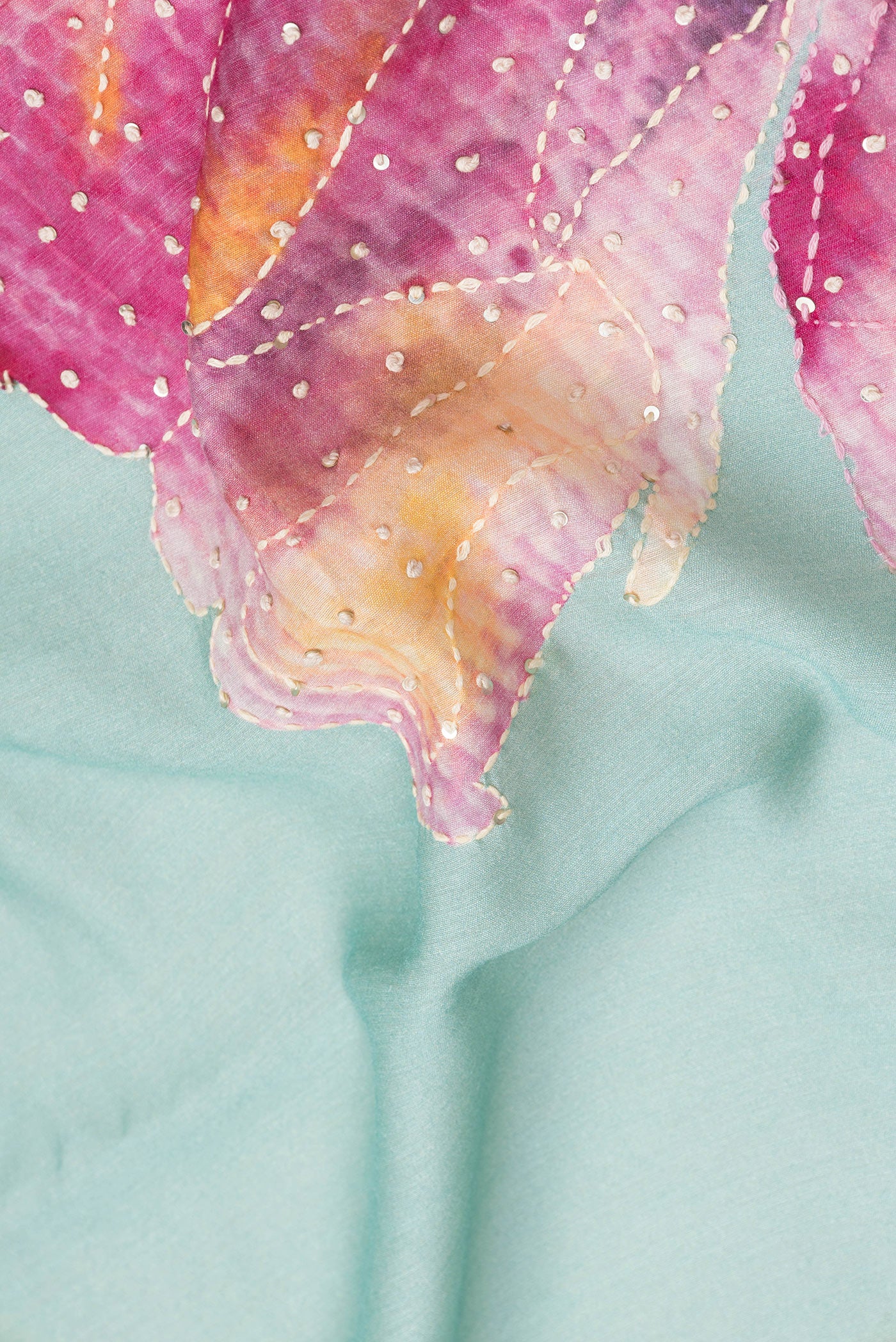 Close up of Sea Green Dual Tone Tussar Silk Saree with Embroidery on the body and Zari Border.  displaying folds