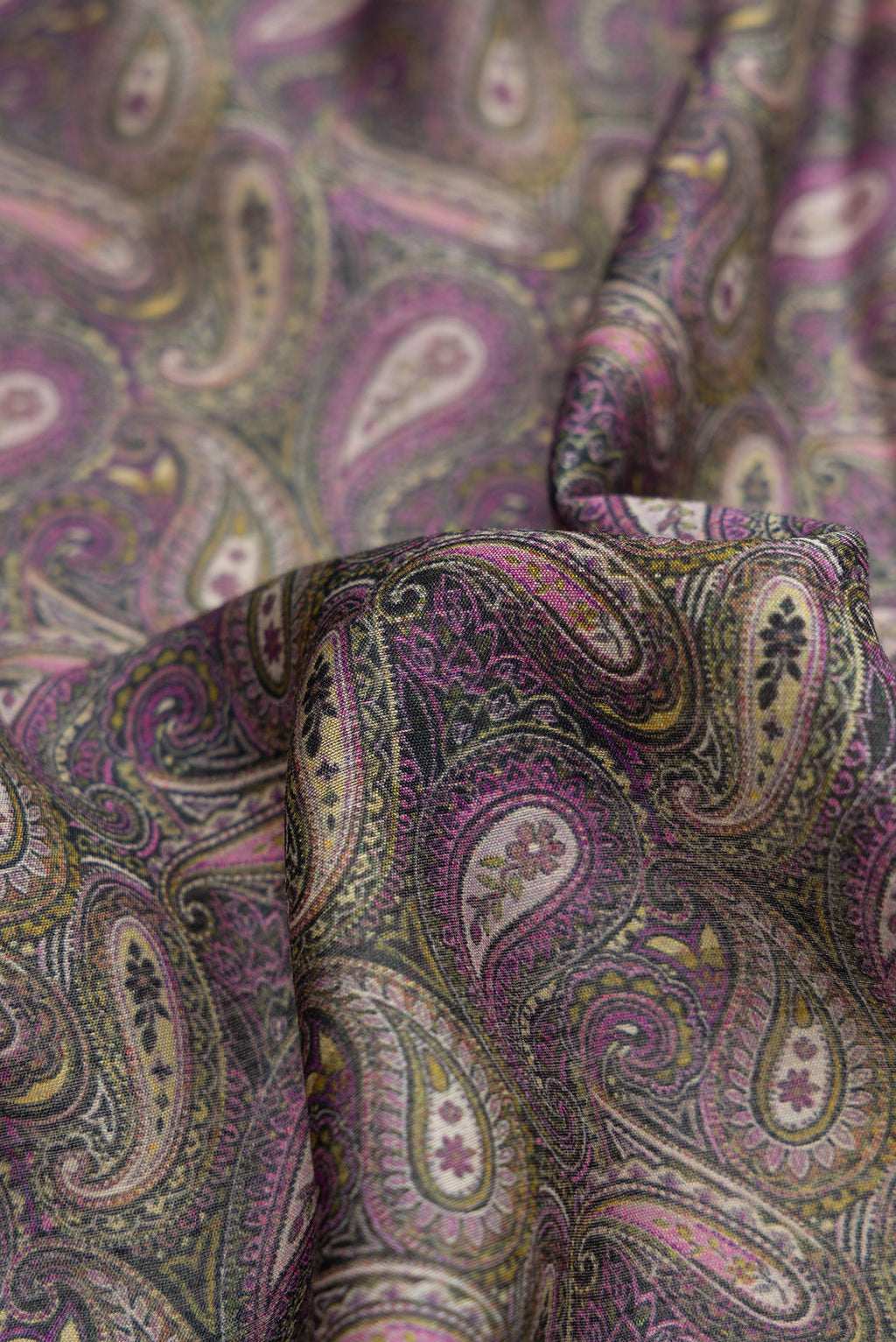 Close up of Purple Dual Tone Tussar Silk Saree with Printed design on the body and Embroidery Border.  displaying folds