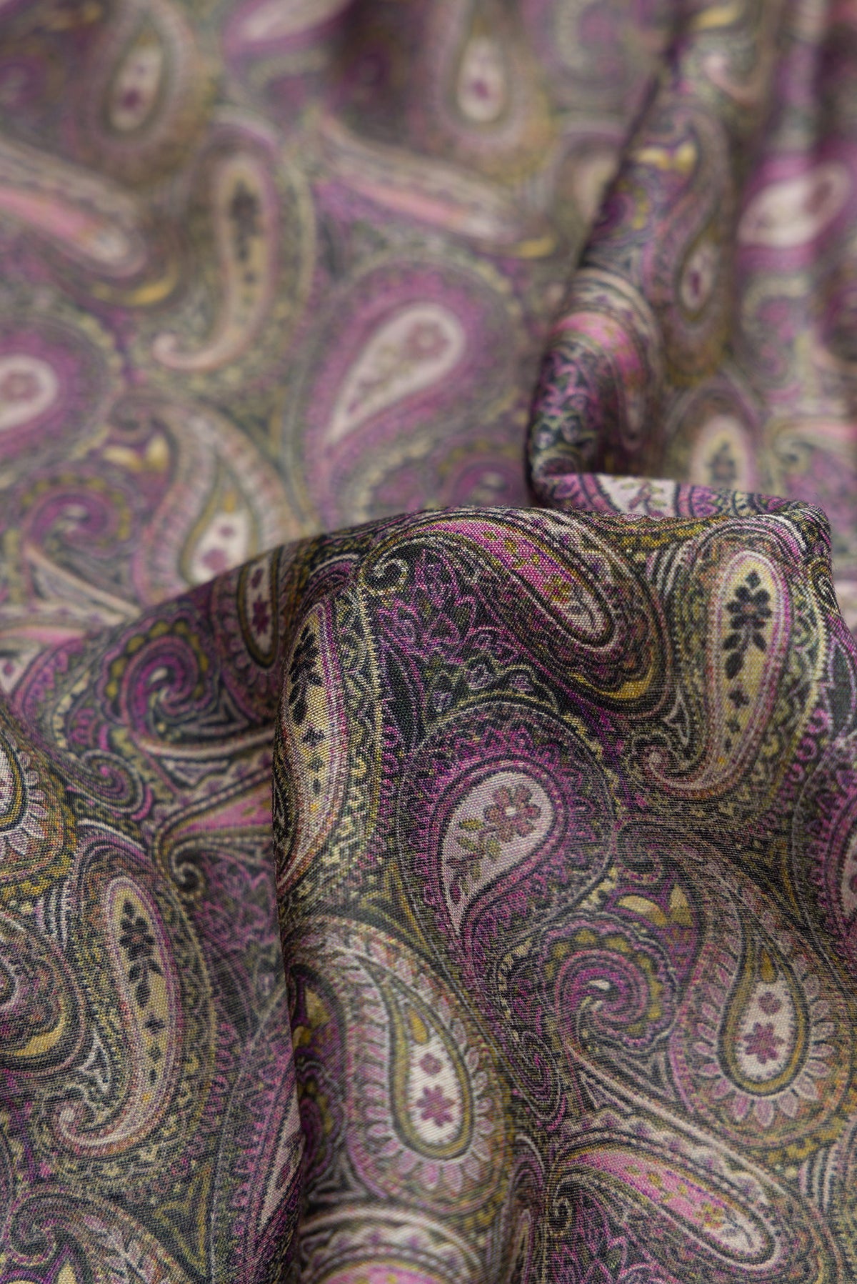 Close up of Purple Dual Tone Tussar Silk Saree with Printed design on the body and Embroidery Border.  displaying folds