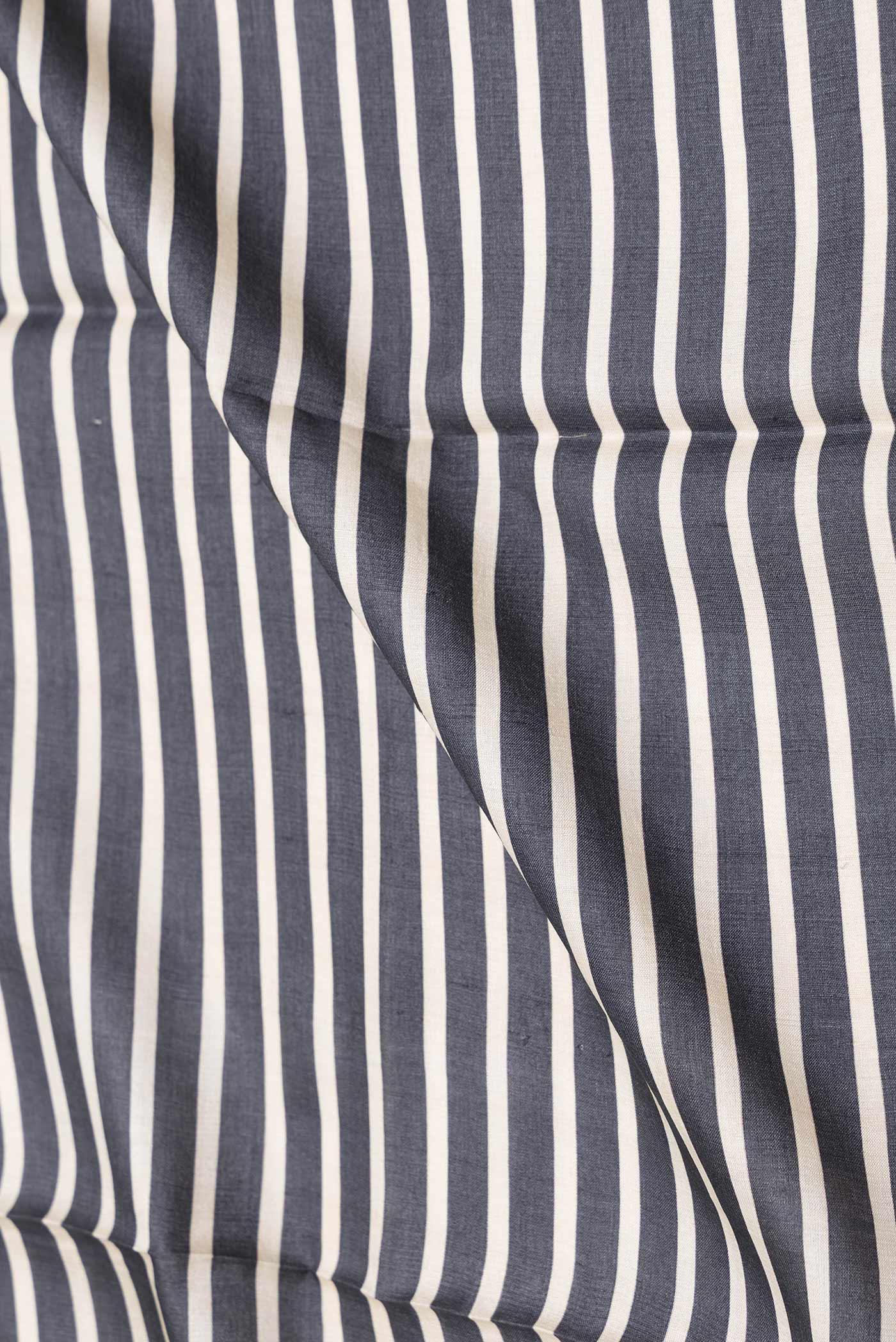 Close up of Black Dual Tone Tussar Saree with Stripes on the body and Embroidery Border displaying folds