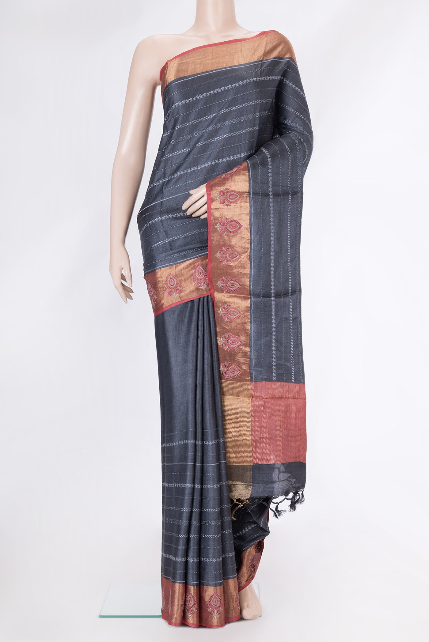 Grey Dual Tone Tussar Silk Saree with Embroidery on the body and Zari Border.  displayed on a mannequin