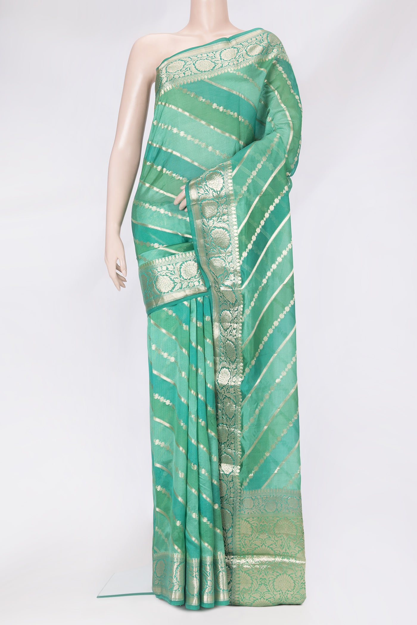 Green Tussar Silk Saree with Zari Brocade on the body and Zari Border.  displayed on a mannequin