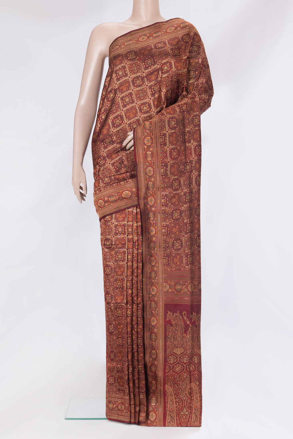 Maroon Banarasi Silk Saree with Checked design on the body and Zari And Thread Border.  displayed on a mannequin