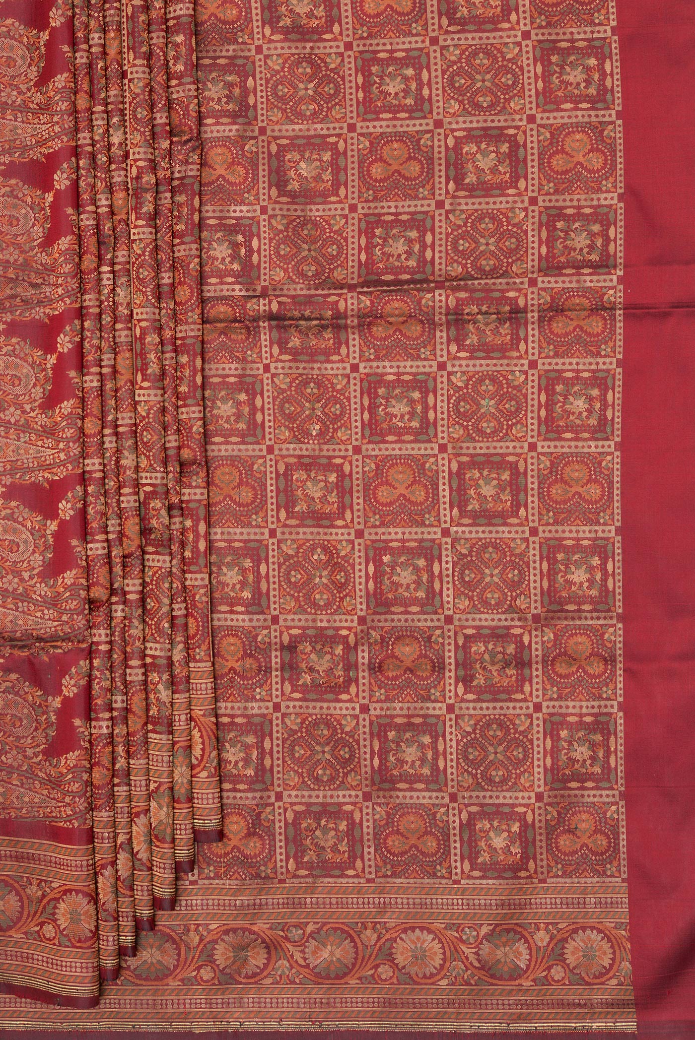 Pleats and pallu of Maroon Banarasi Silk Saree with Checked design on the body and Zari And Thread Border. 