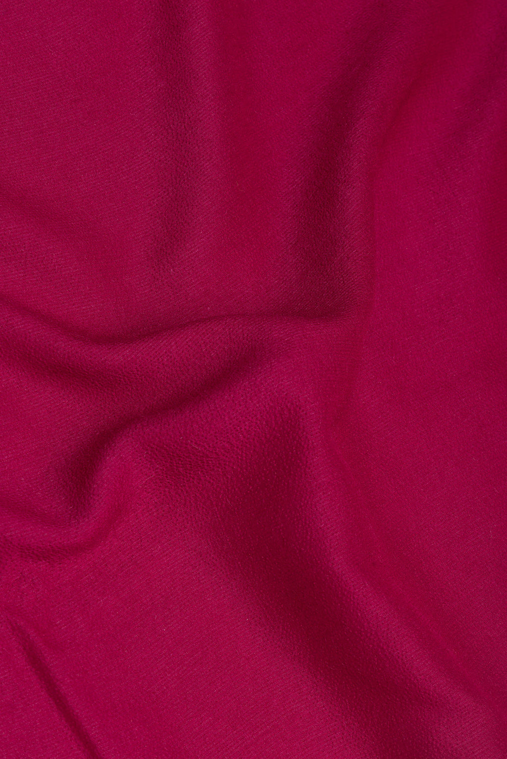 Close up of Magenta Tussar Silk Saree with Zari Butta on the body and Fancy Border.  displaying folds
