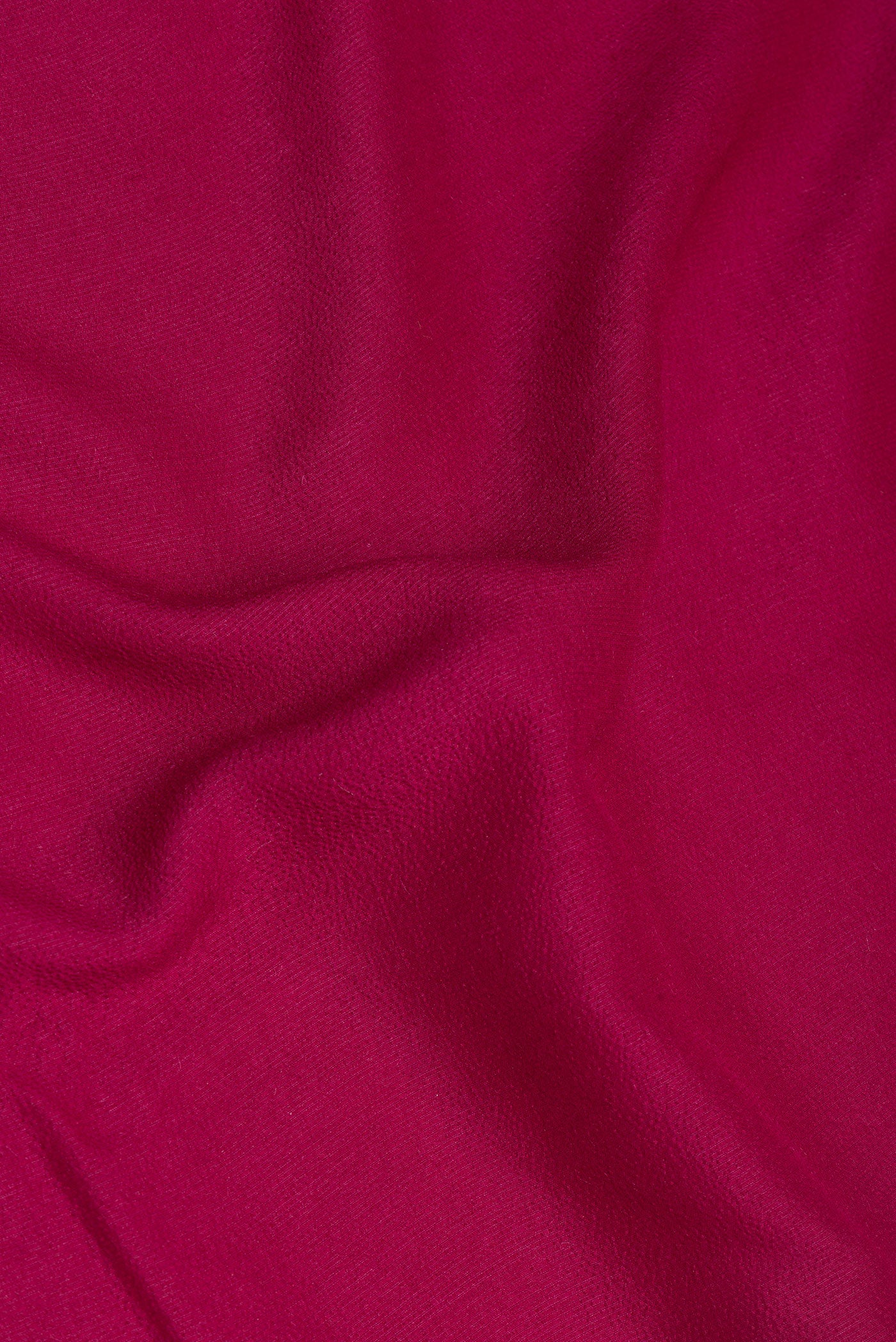 Close up of Magenta Tussar Silk Saree with Zari Butta on the body and Fancy Border.  displaying folds