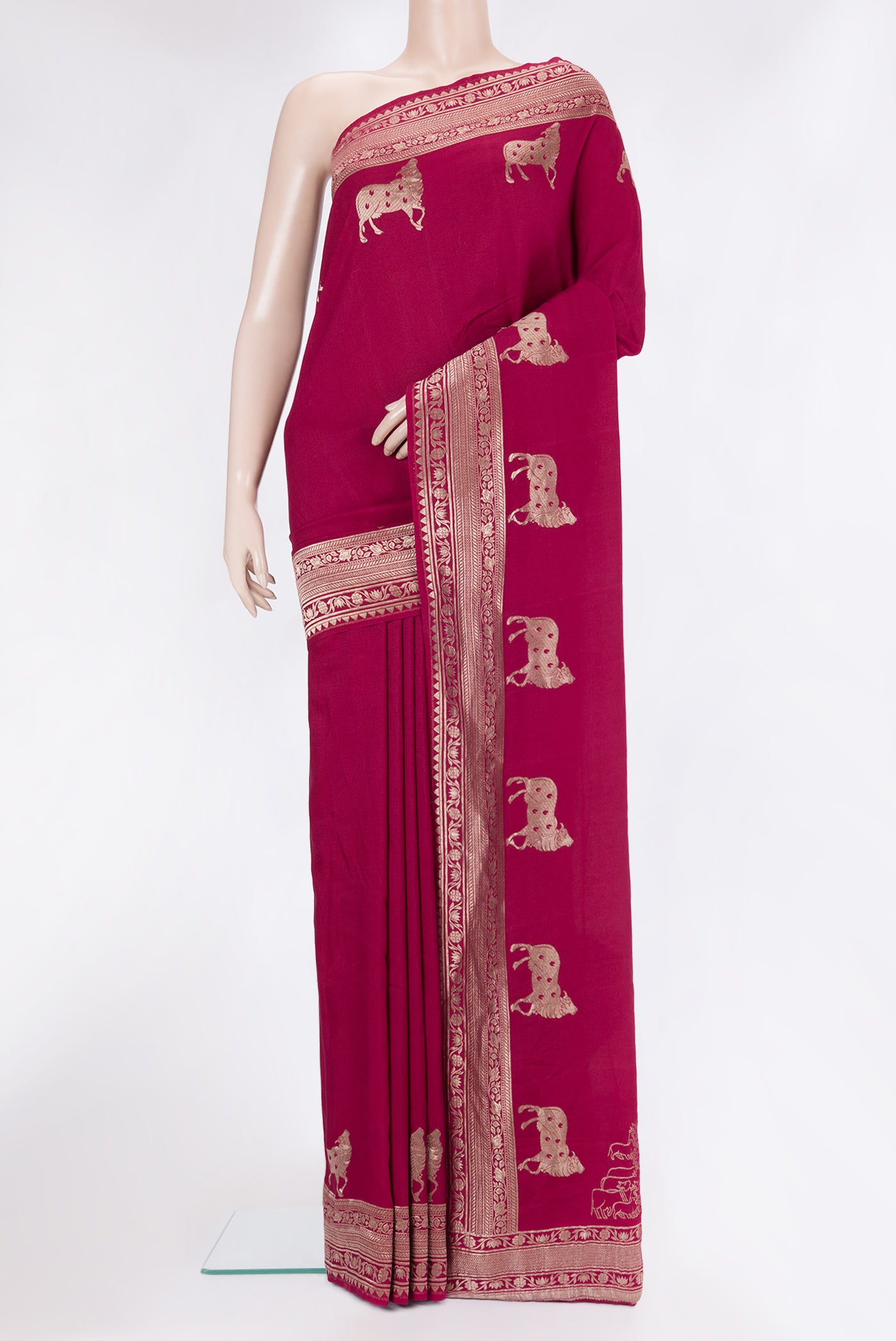 Magenta Tussar Silk Saree with Zari Butta on the body and Fancy Border.  displayed on a mannequin