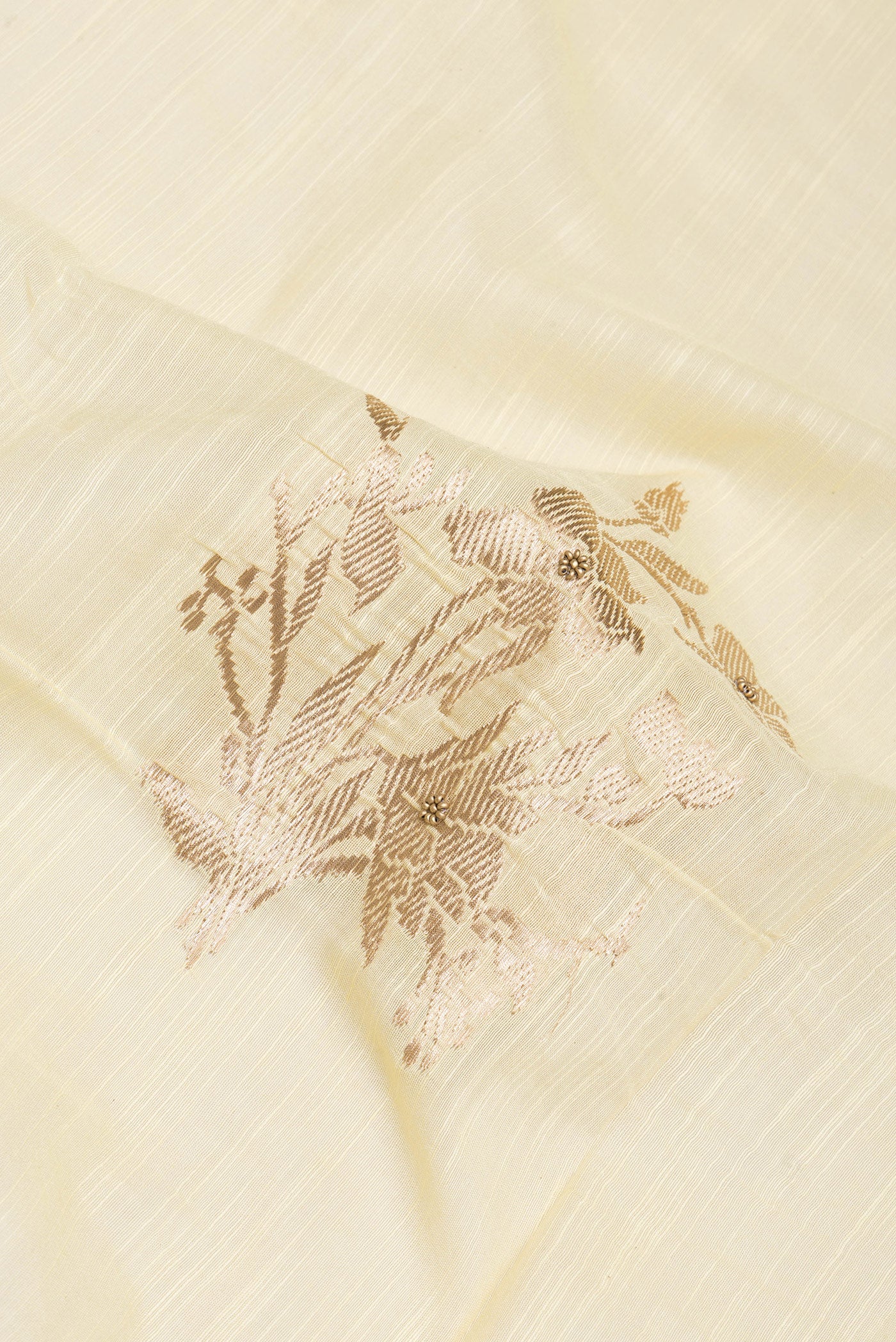 Close up of Sandal Tussar Silk Saree with Embroidery on the body and Embroidery Border.  displaying folds