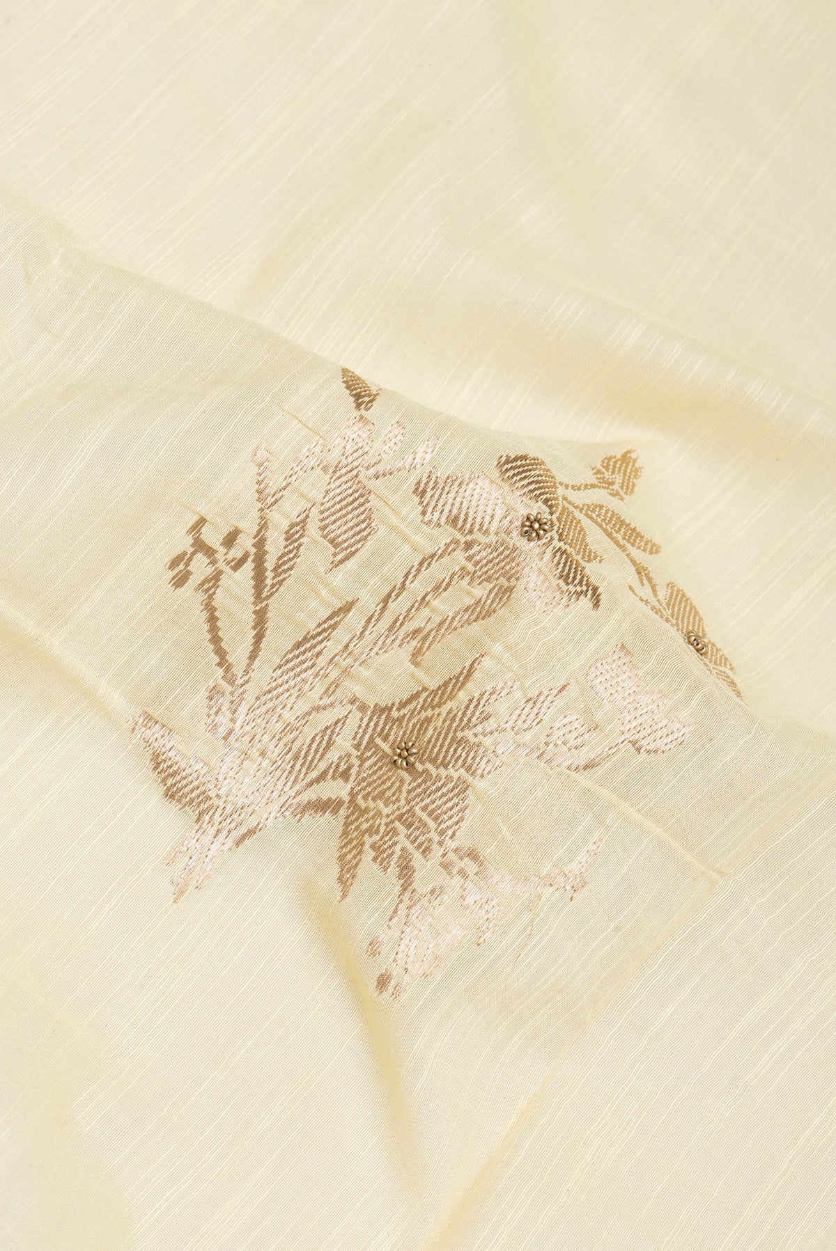Close up of Sandal Tussar Silk Saree with Embroidery on the body and Embroidery Border.  displaying folds