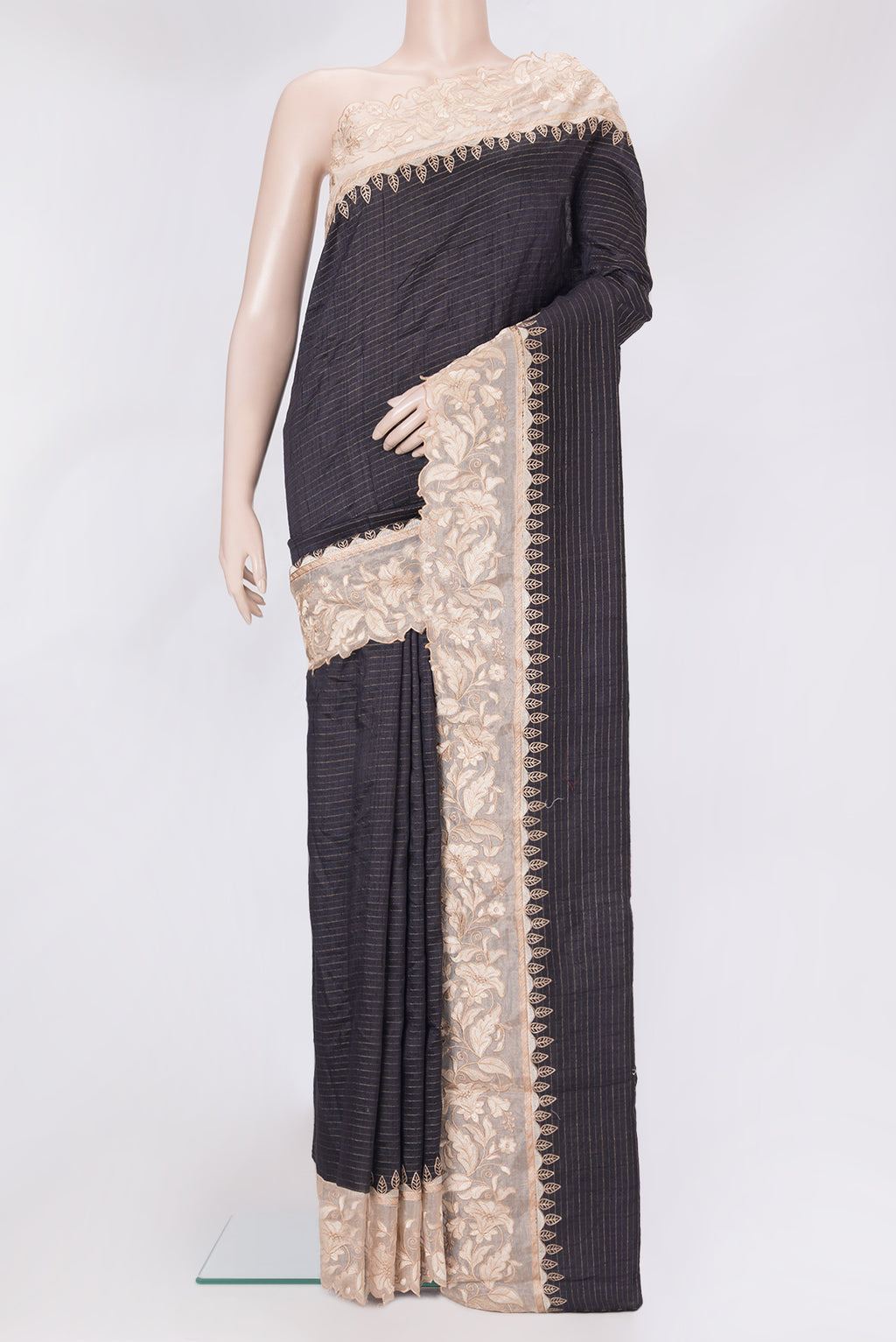 Black Tussar Silk Saree with Stripes on the body and Embroidery Border.  displayed on a mannequin
