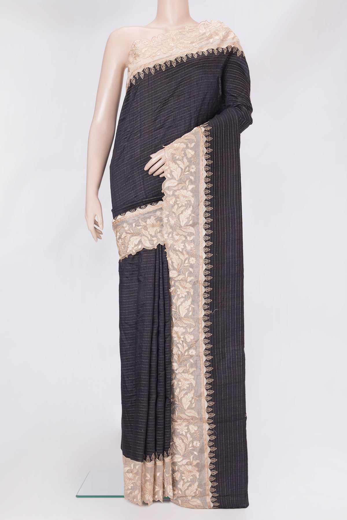 Black Tussar Silk Saree with Stripes on the body and Embroidery Border.  displayed on a mannequin