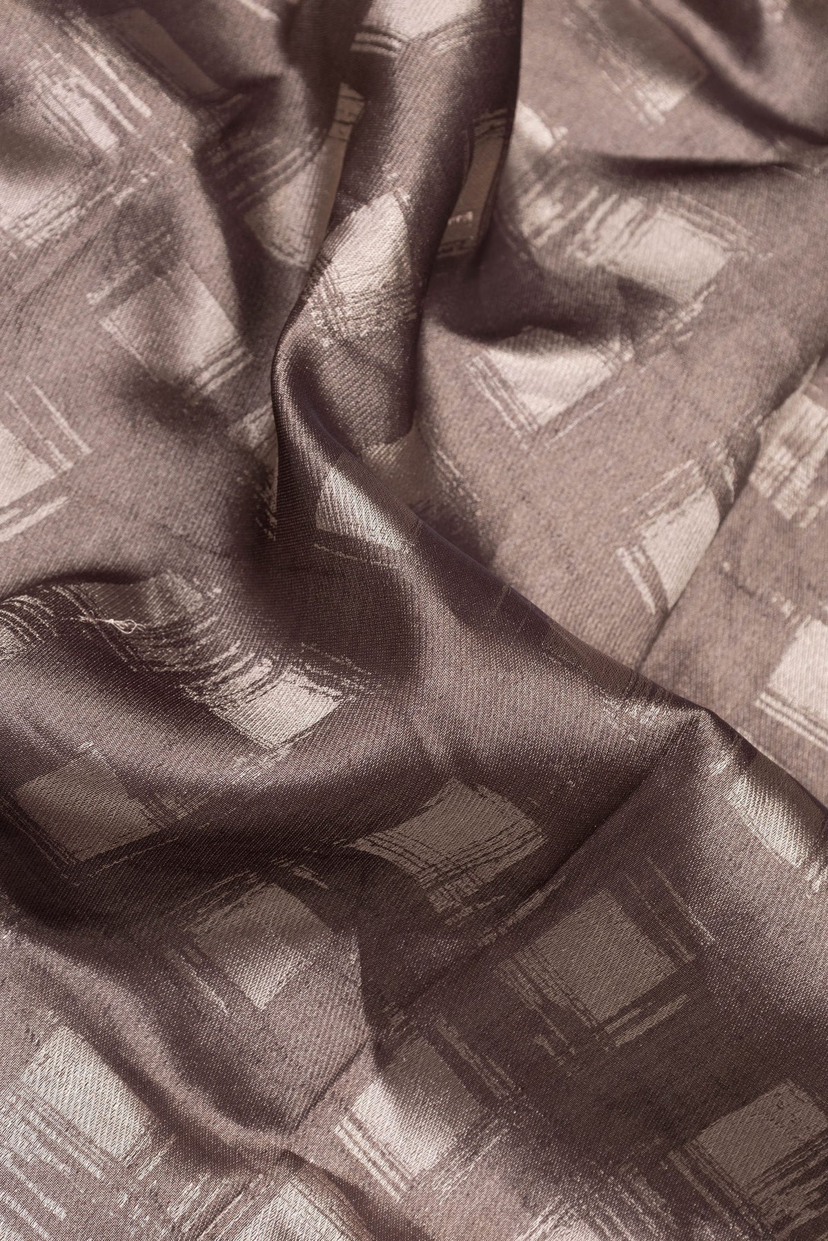Close up of Brown Dual Tone Banarasi Silk Saree with Zari Brocade on the body and Zari Border.  displaying folds