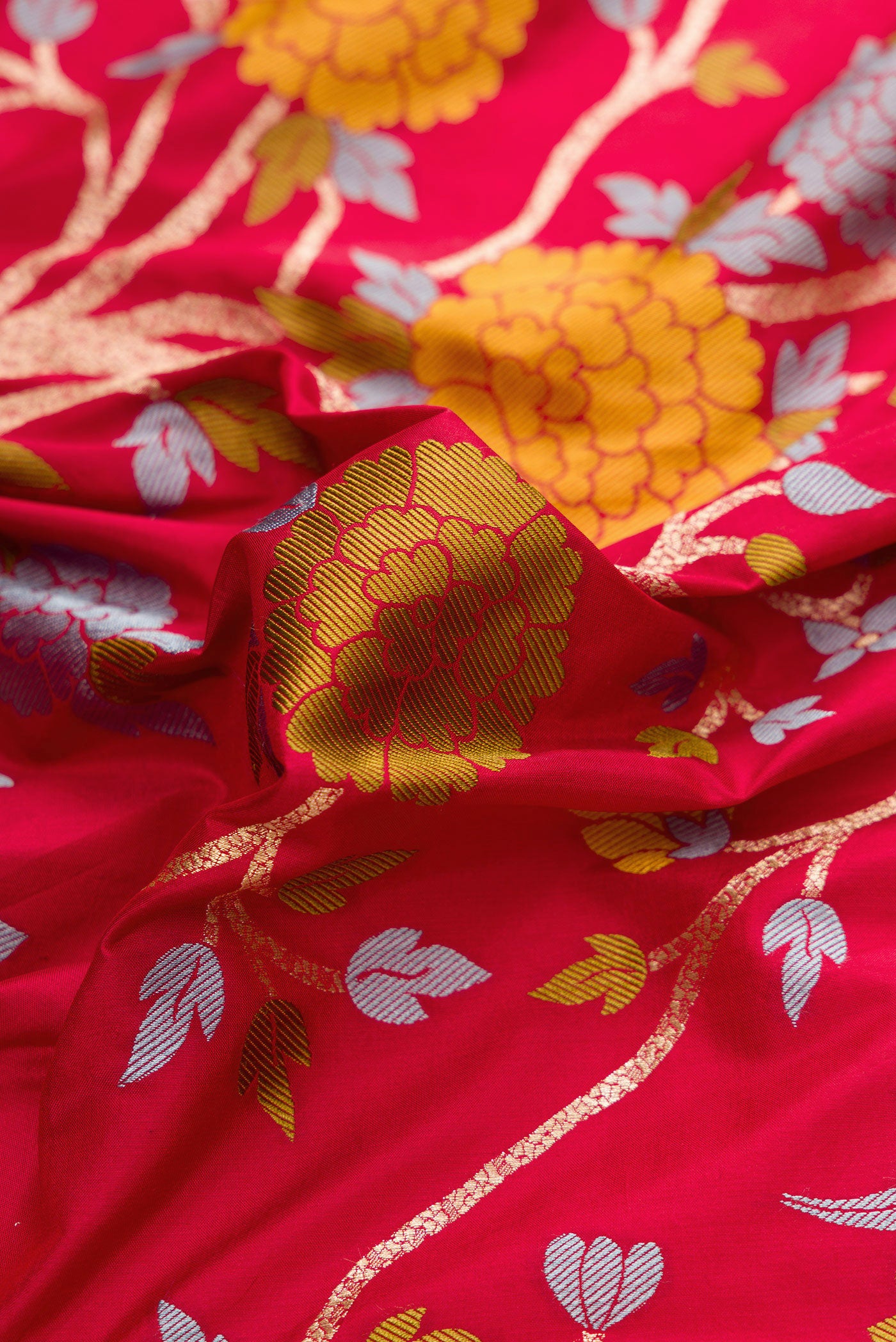 Close up of Maroon Dual Tone Banarasi Silk Saree with Zari Brocade on the body and Fancy Border.  displaying folds