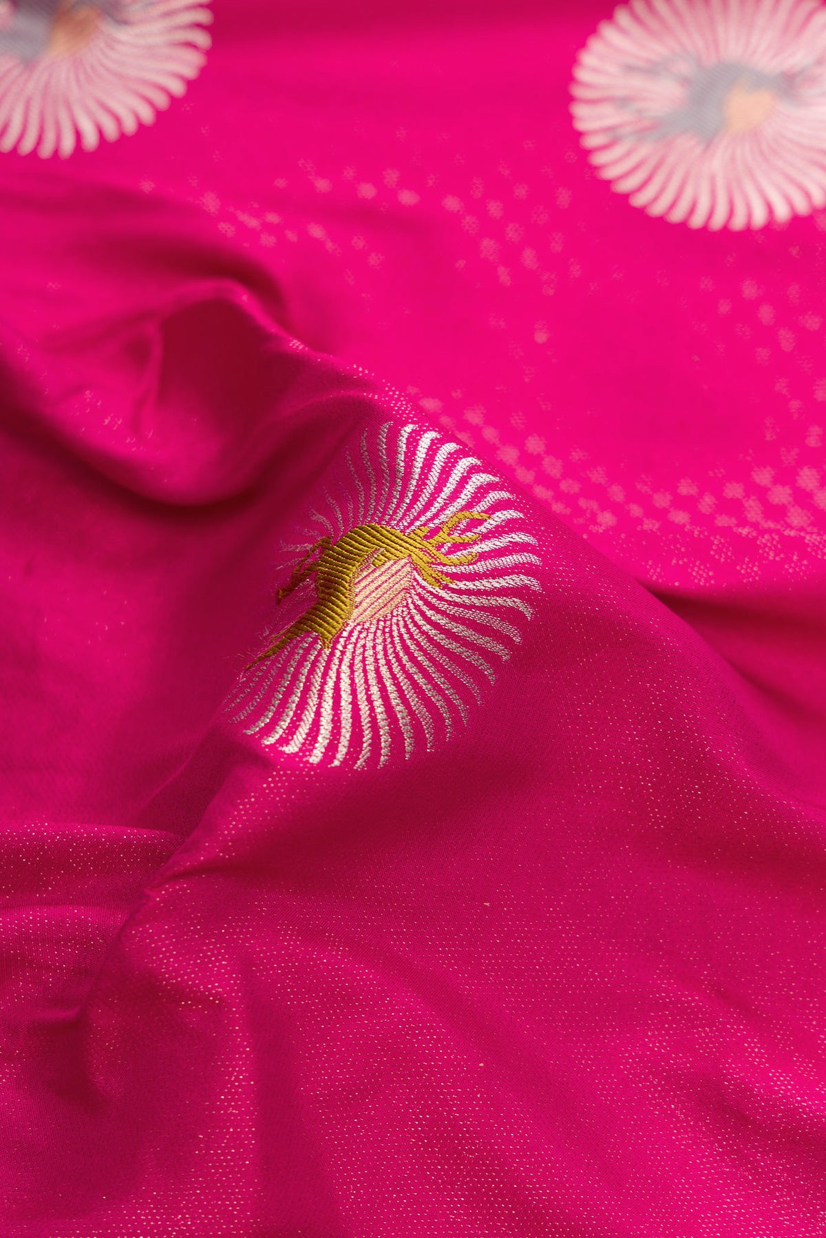 Close up of Dark Pink Dual Tone Banarasi Silk Saree with Zari Brocade on the body and Fancy Border.  displaying folds