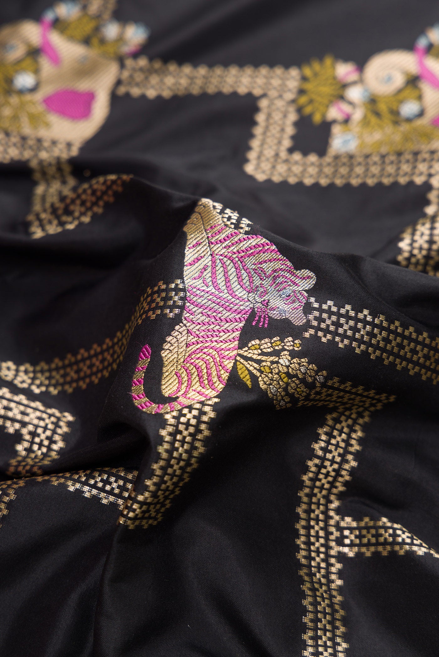 Close up of Black Dual Tone Banarasi Silk Saree with Zari Brocade on the body and Fancy Border.  displaying folds