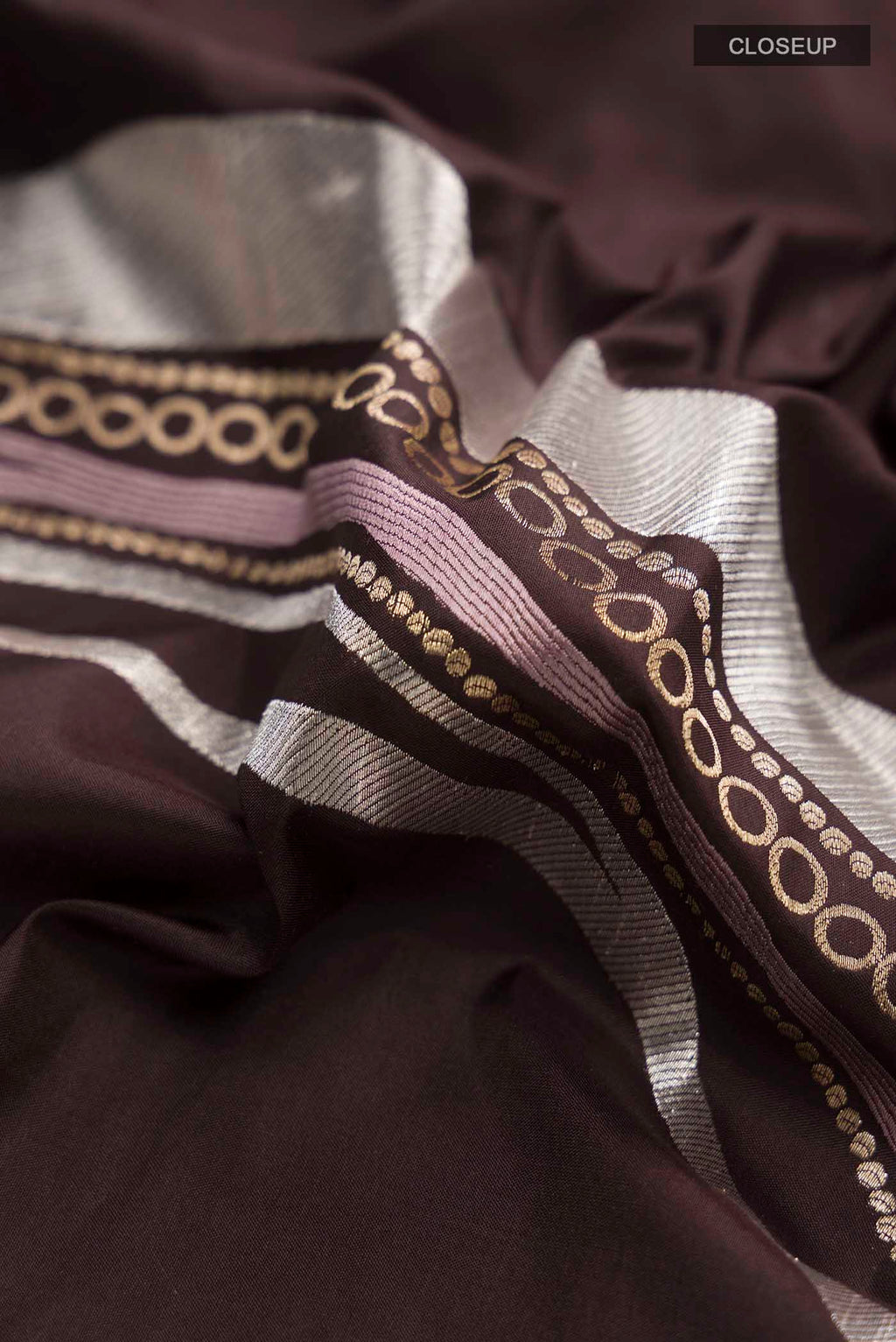 Close up of Brown Banarasi Silk Saree with Zari Butta on the body and Zari Border displaying folds