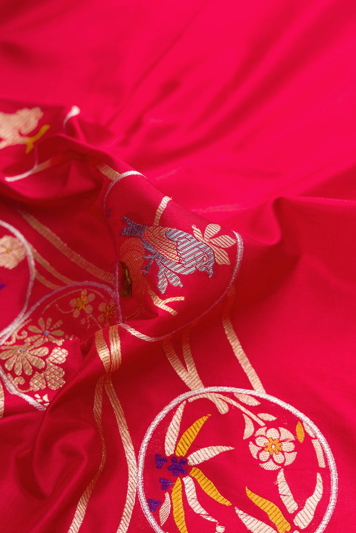 Close up of Red Dual Tone Banarasi Silk Saree with Zari Brocade on the body and Zari Border.  displaying folds