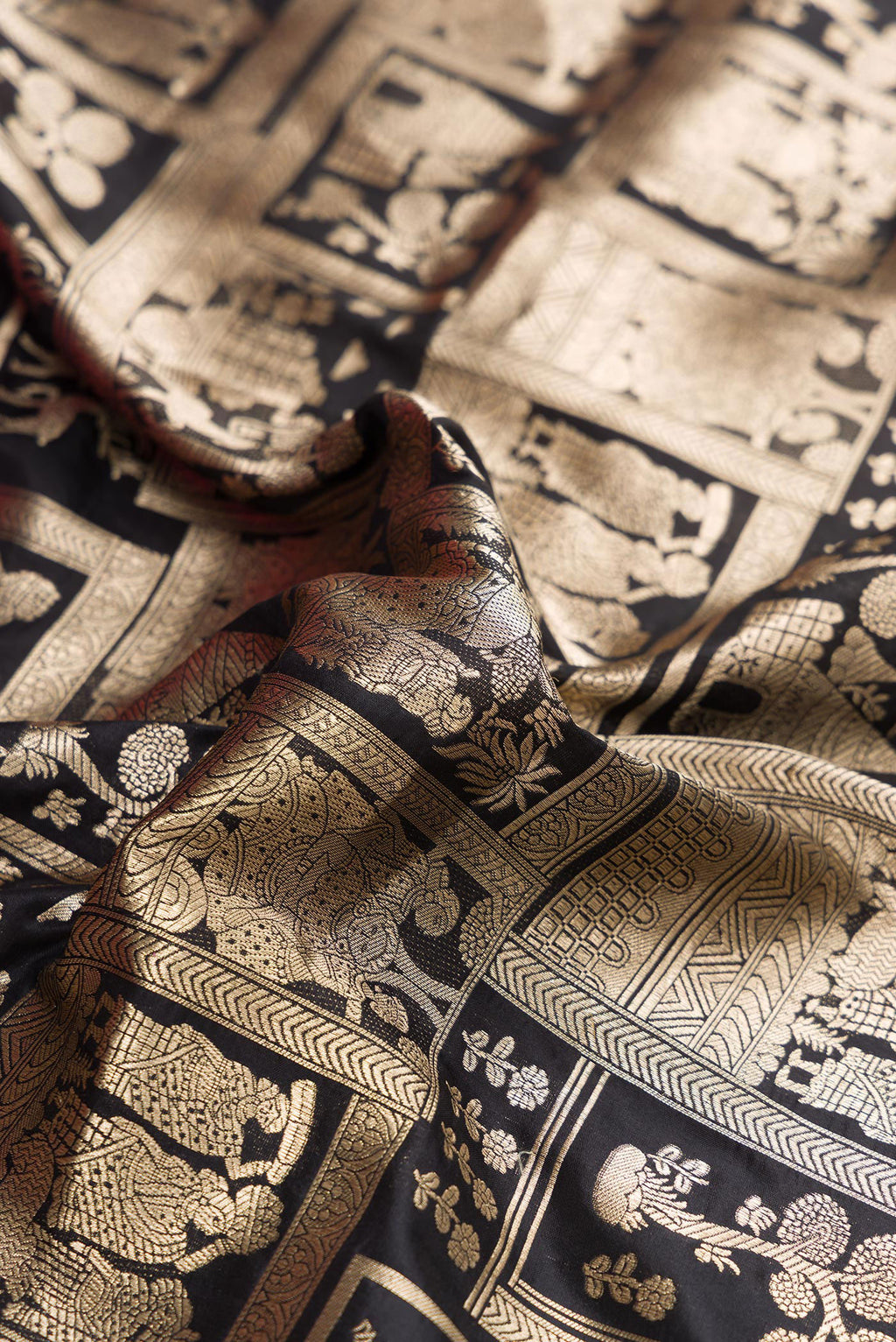 Close up of Black Dual Tone Banarasi Silk Saree with Zari Brocade on the body and Zari Border.  displaying folds