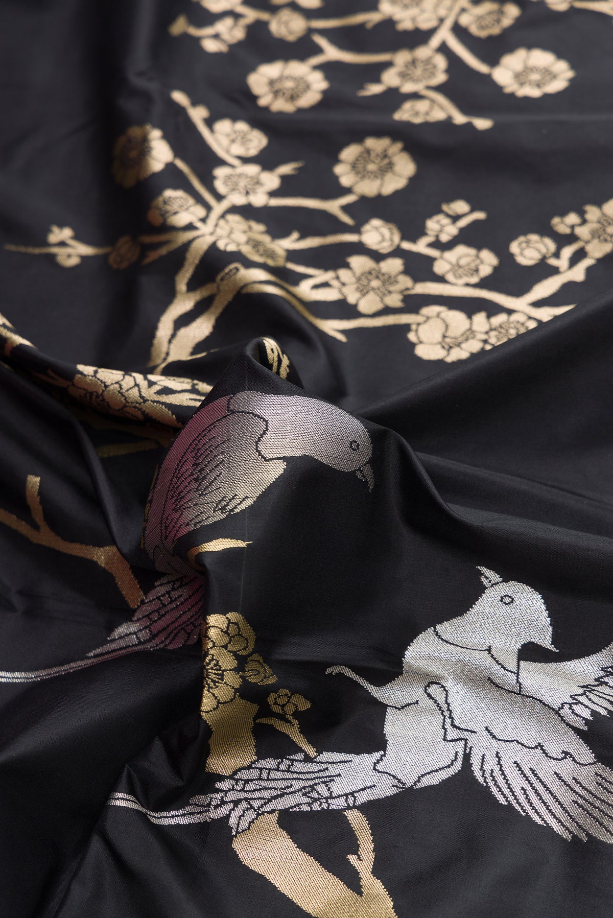 Close up of Black Dual Tone Banarasi Silk Saree with Zari Brocade on the body and Fancy Border.  displaying folds