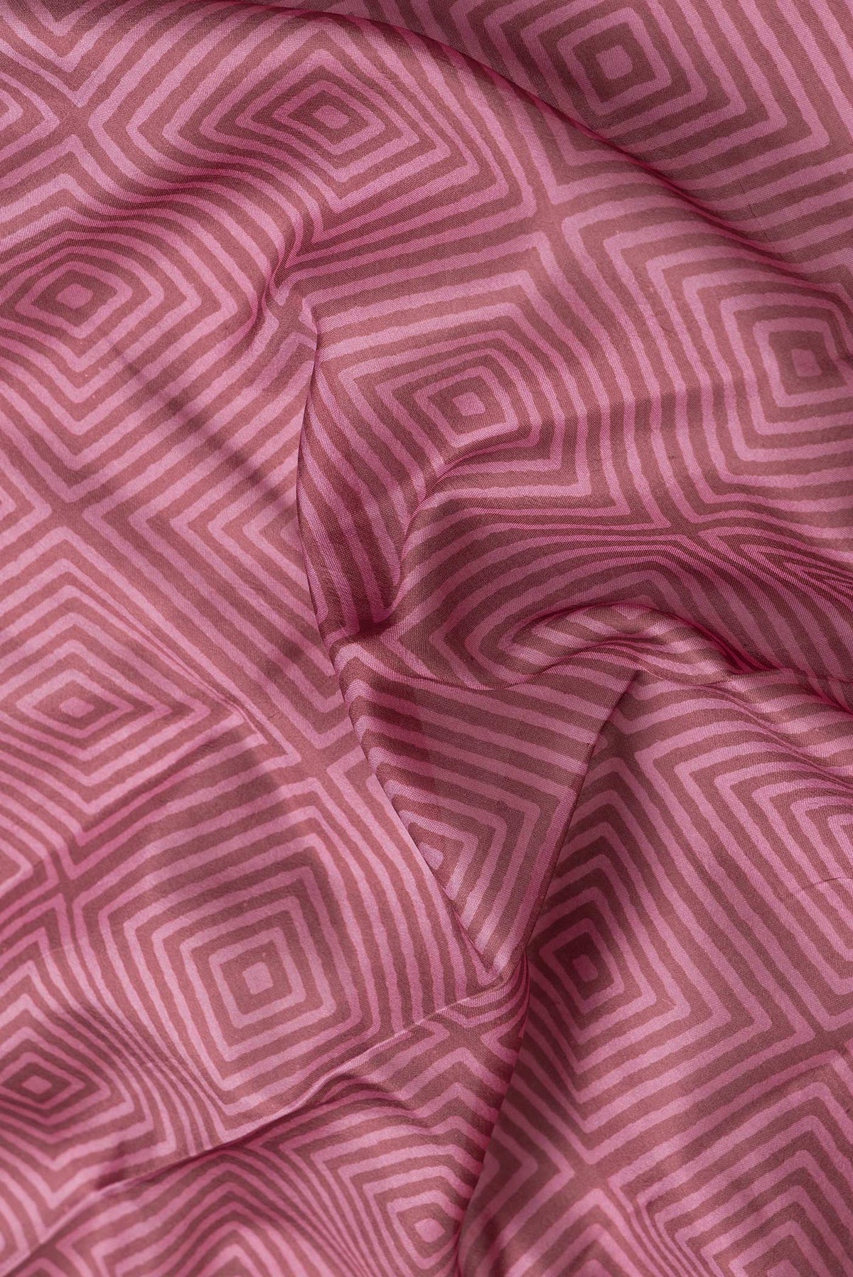 Close up of Brown Dual Tone Printed Silk Saree with Printed design on the body and Thread Border.  displaying folds
