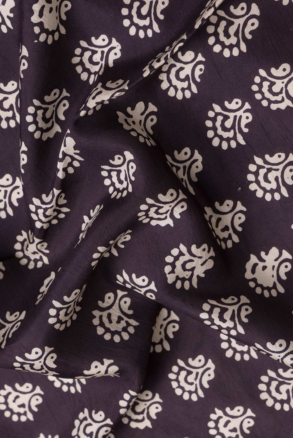 Close up of Burgundy Dual Tone Printed Silk Saree with Printed design on the body and Printed Border.  displaying folds