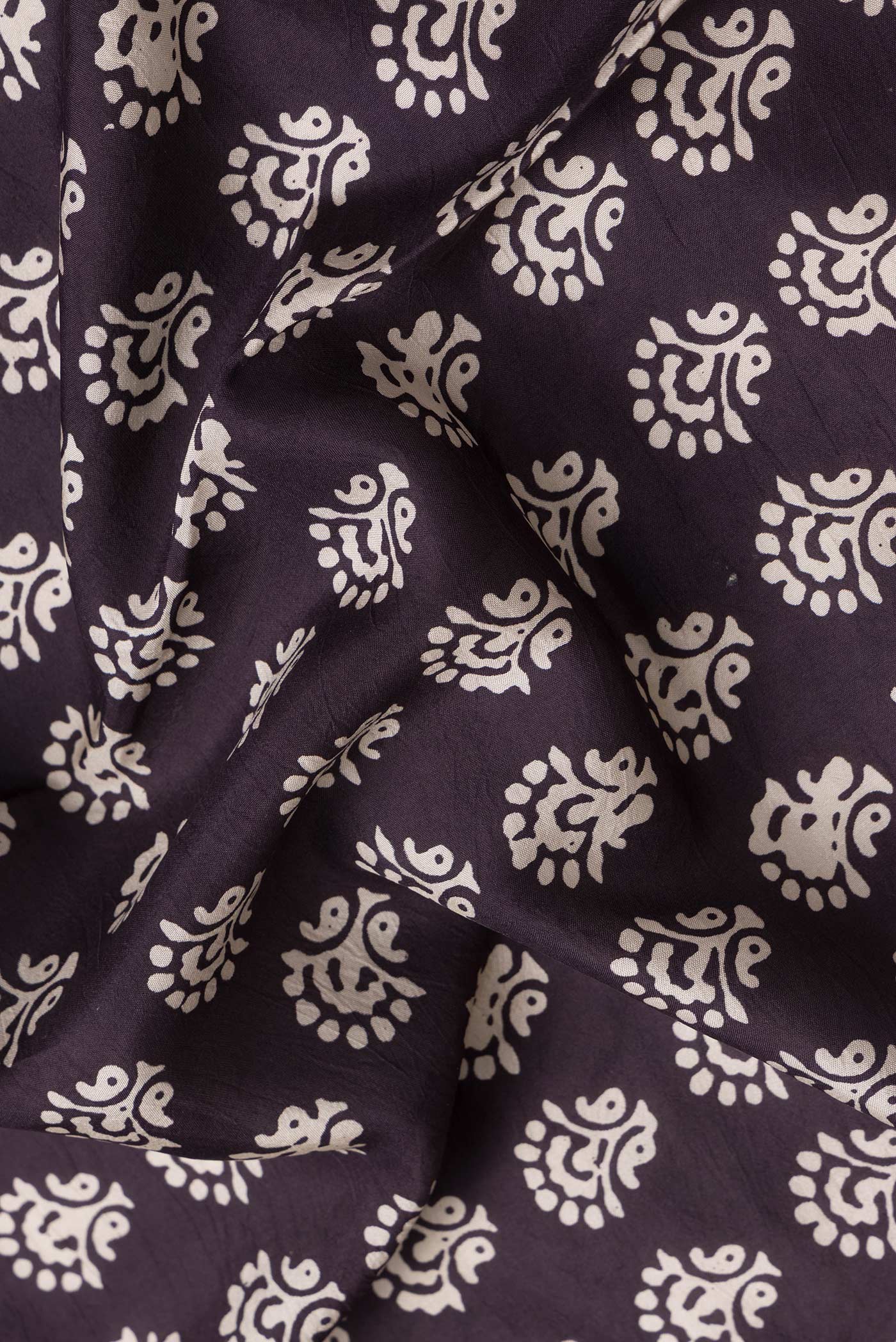 Close up of Burgundy Dual Tone Printed Silk Saree with Printed design on the body and Printed Border.  displaying folds