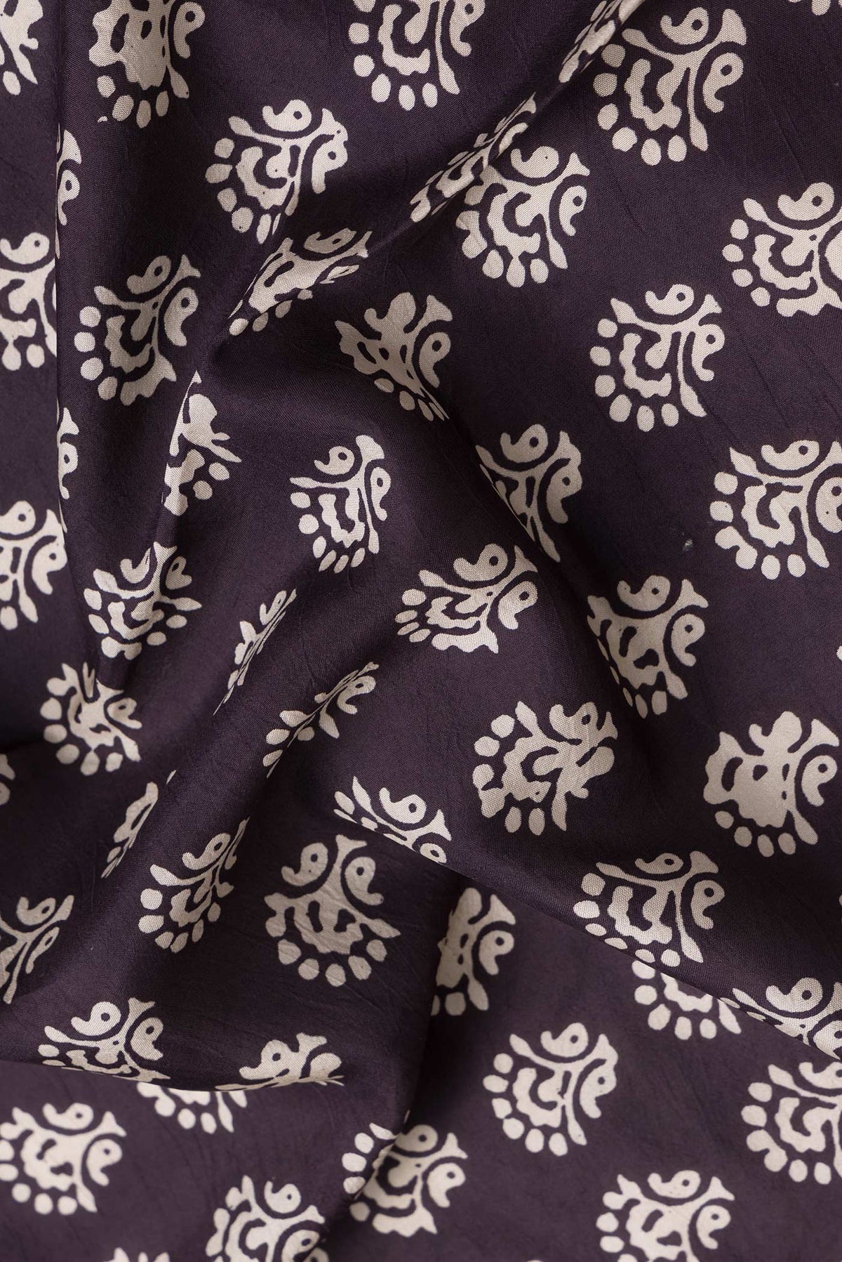 Close up of Burgundy Dual Tone Printed Silk Saree with Printed design on the body and Printed Border.  displaying folds