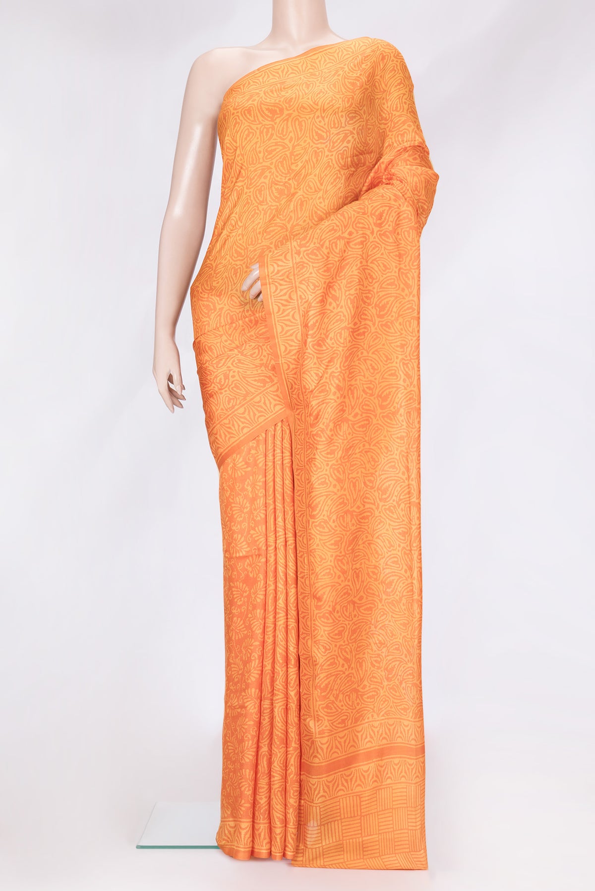 Orange Dual Tone Printed Silk Saree with Printed design on the body and Printed Border.  displayed on a mannequin