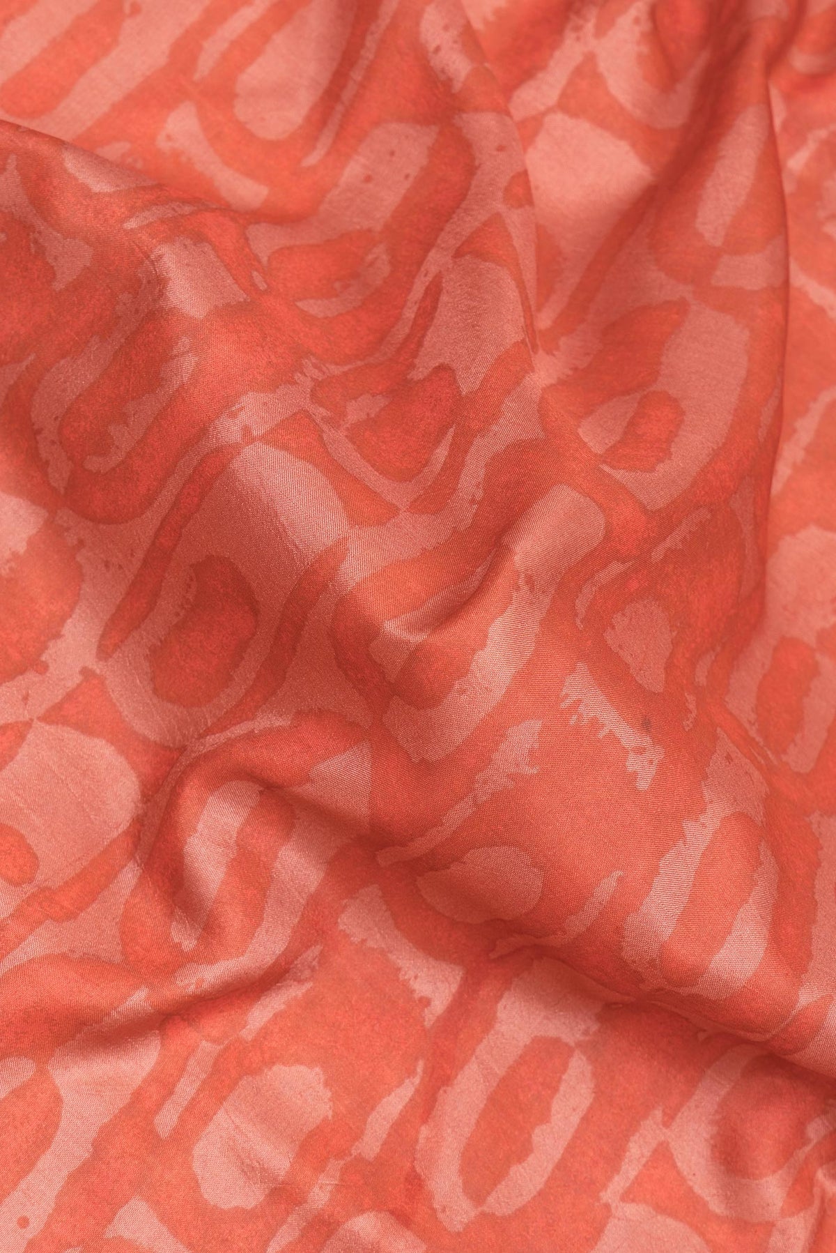 Close up of Pure Silk Peach Dual Tone Tussar Saree with Printed design on the body and Printed Border.  displaying folds