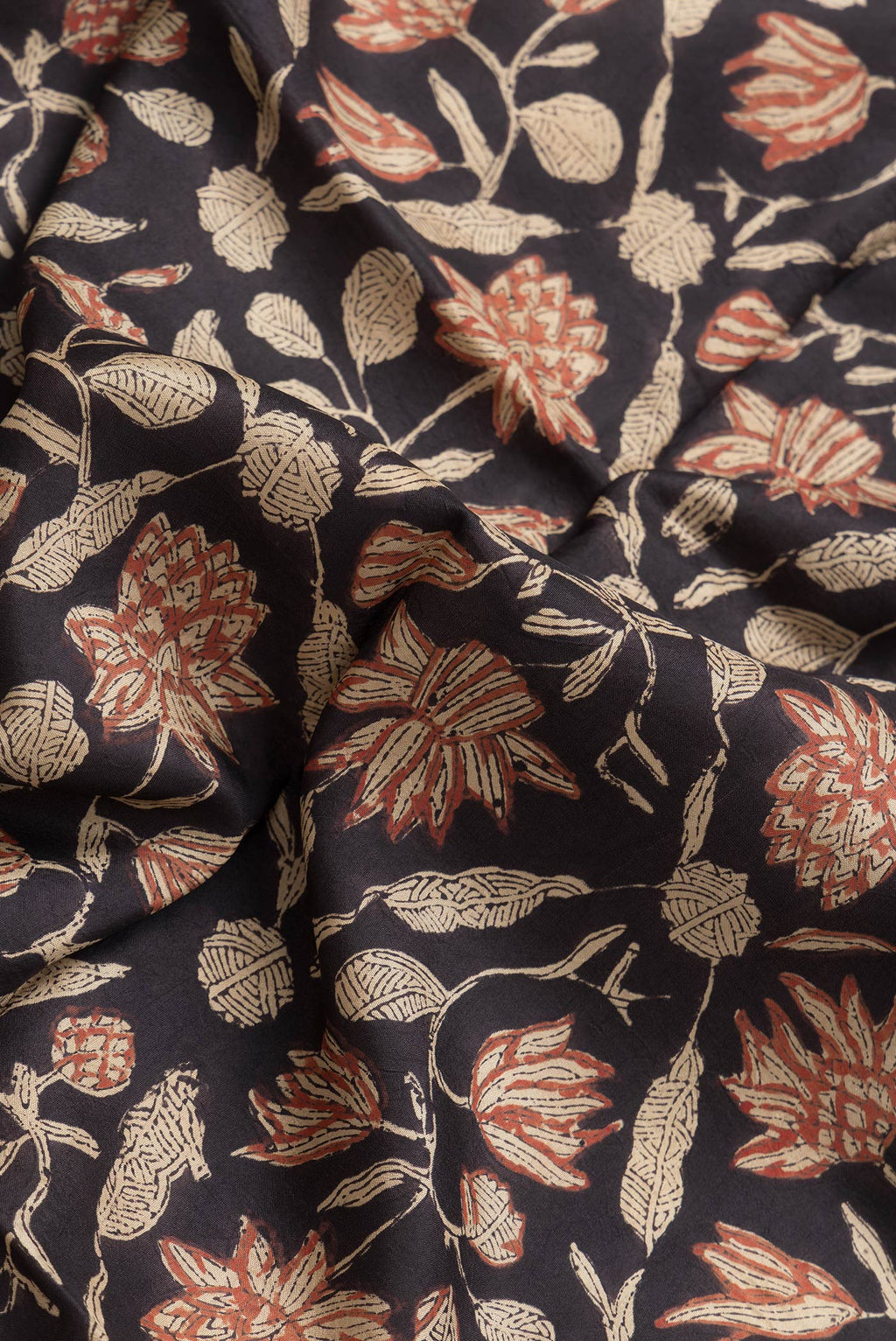 Close up of Brown Dual Tone Printed Silk Saree with Printed design on the body and Printed Border.  displaying folds