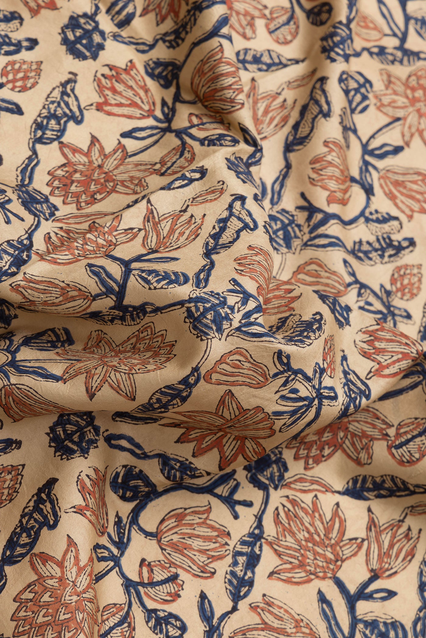 Close up of Beige Dual Tone Printed Silk Saree with Printed design on the body and Printed Border.  displaying folds
