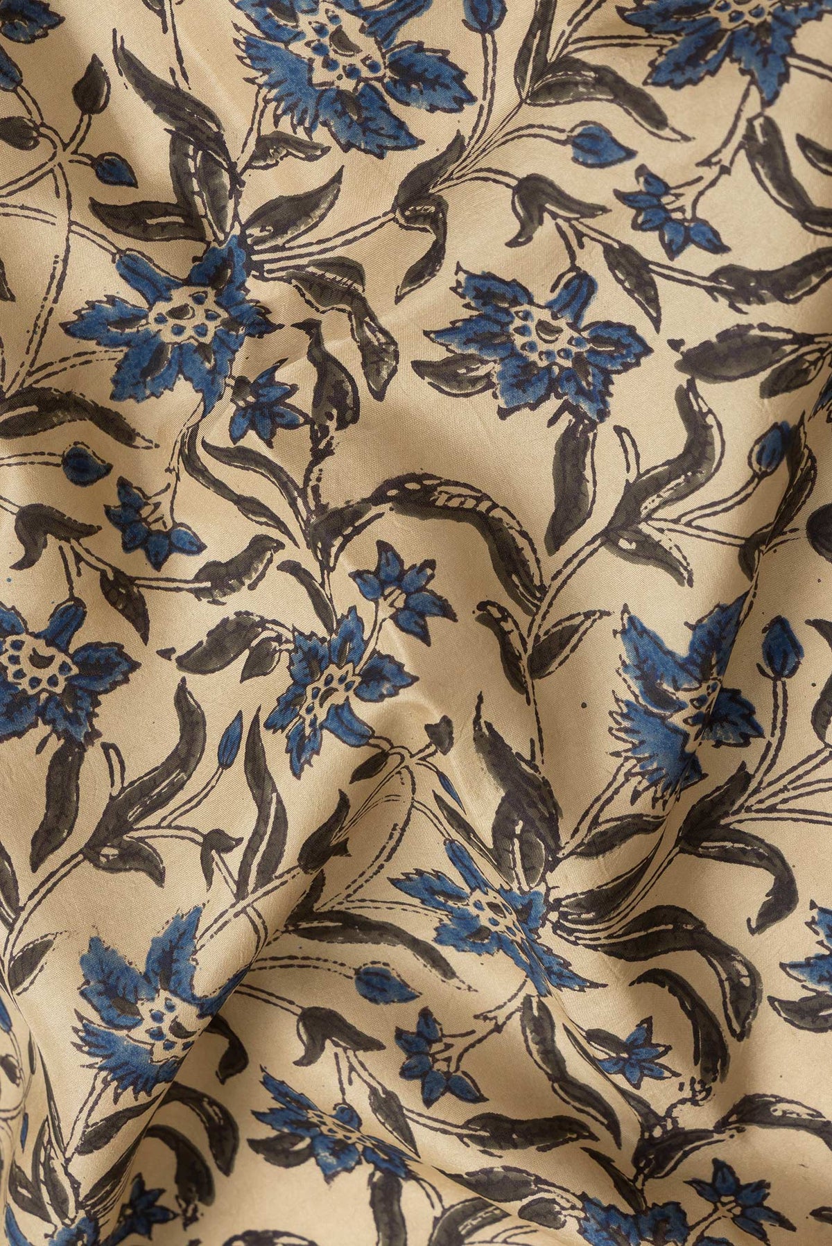 Close up of Beige Dual Tone Printed Silk Saree with Printed design on the body and Printed Border.  displaying folds