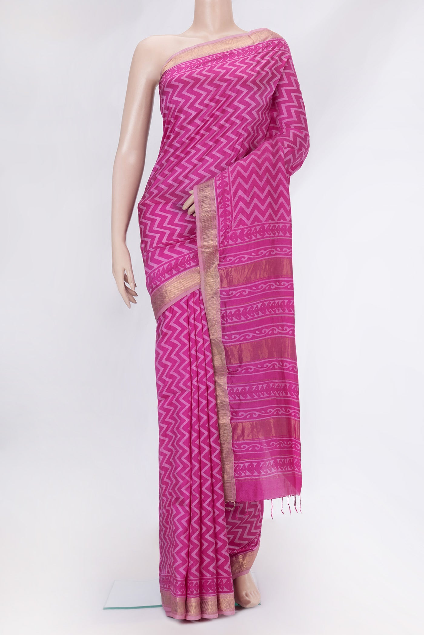 Pink Tussar Silk Saree with Printed design on the body and Zari Border.  displayed on a mannequin