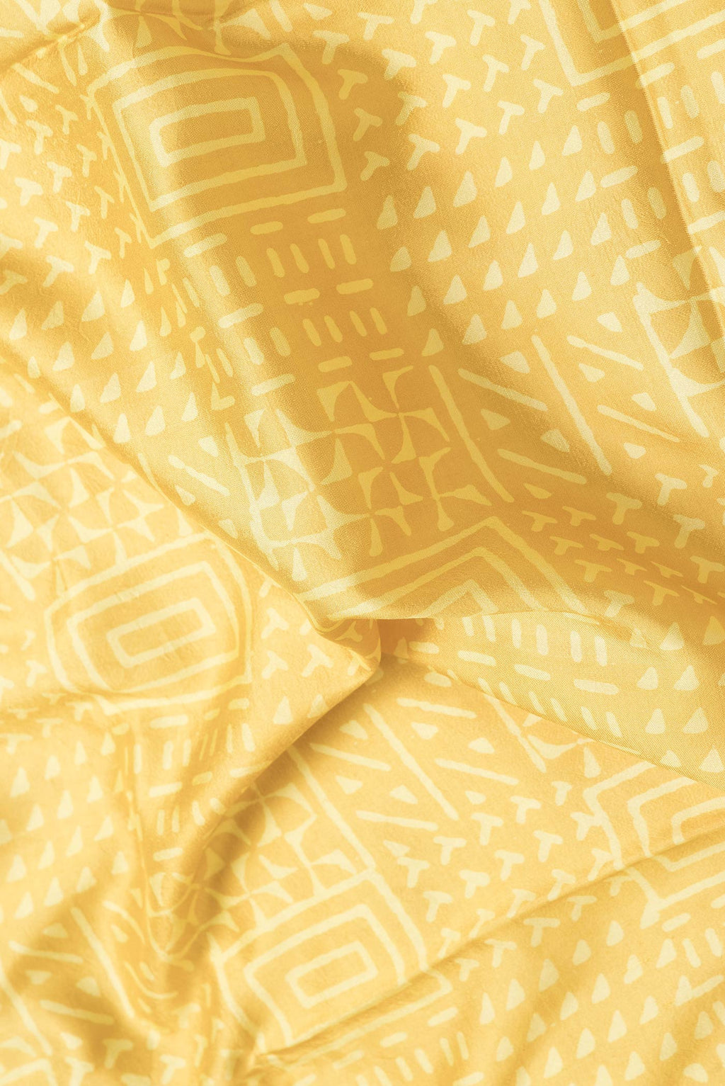 Close up of Mustard Dual Tone Printed Silk Saree with Printed design on the body and Zari Border.  displaying folds