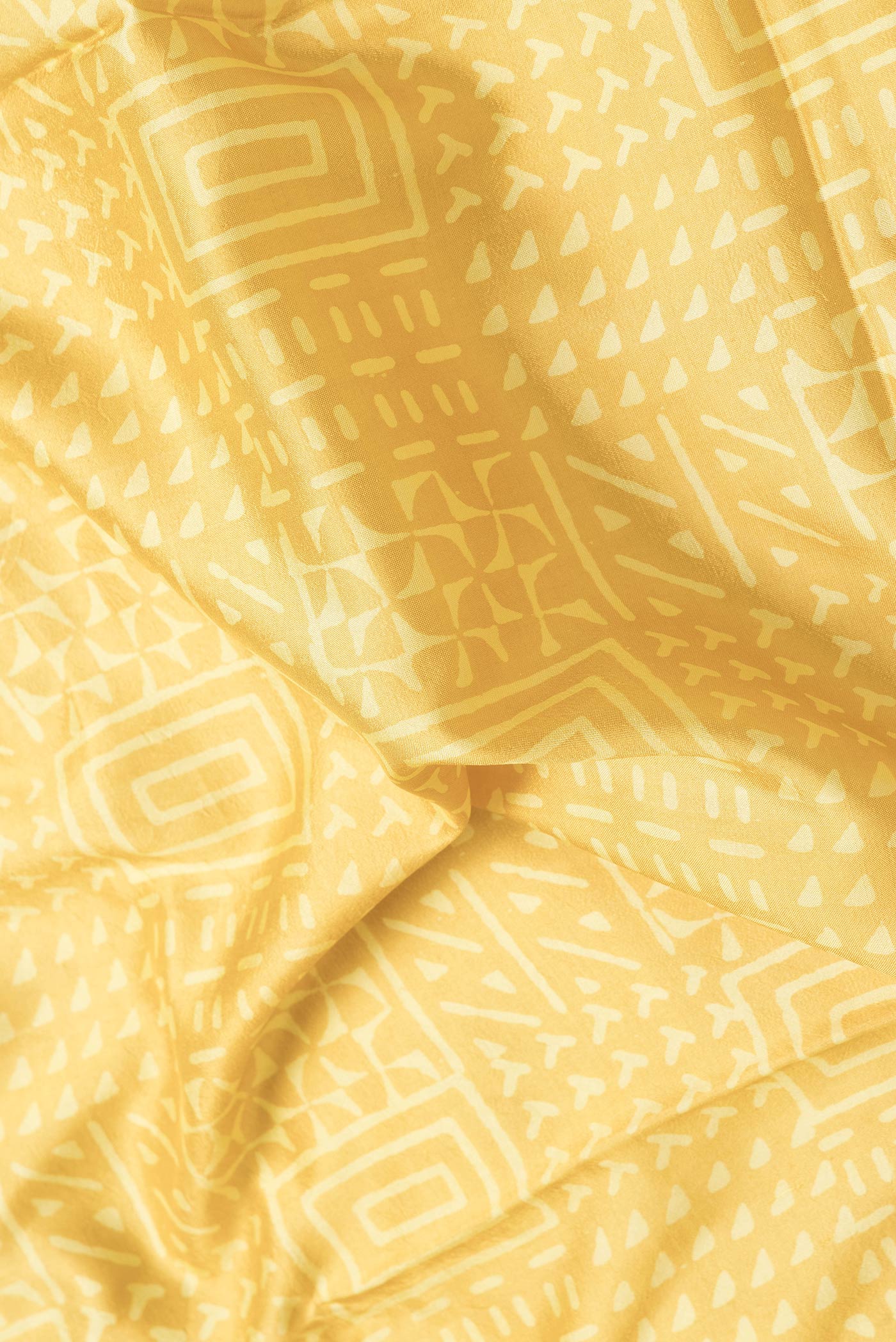 Close up of Mustard Dual Tone Printed Silk Saree with Printed design on the body and Zari Border.  displaying folds