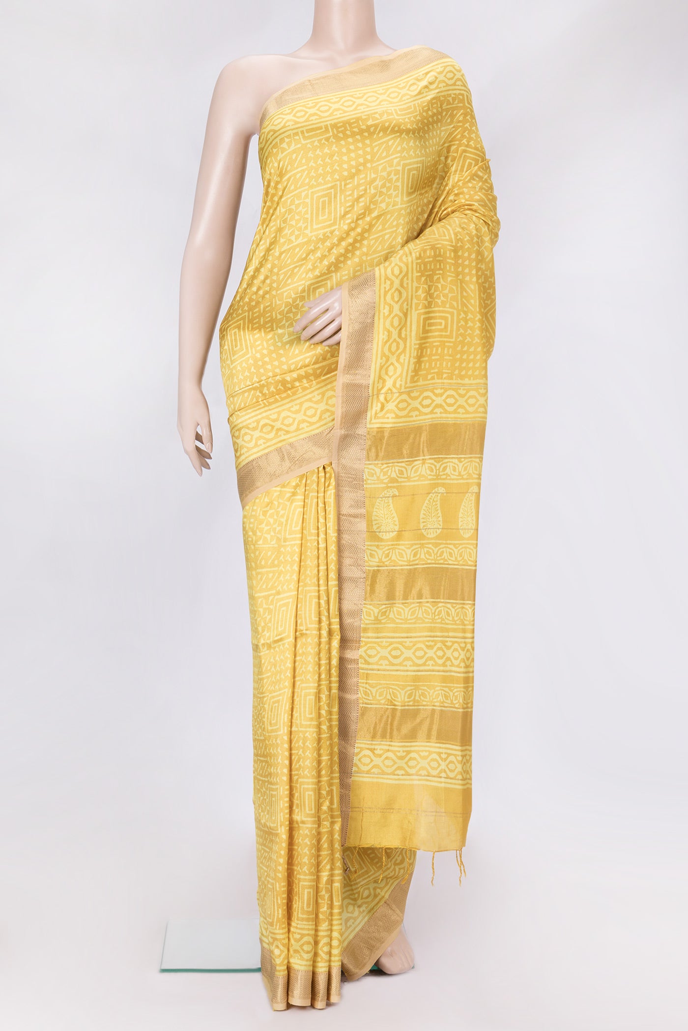 Mustard Dual Tone Printed Silk Saree with Printed design on the body and Zari Border.  displayed on a mannequin